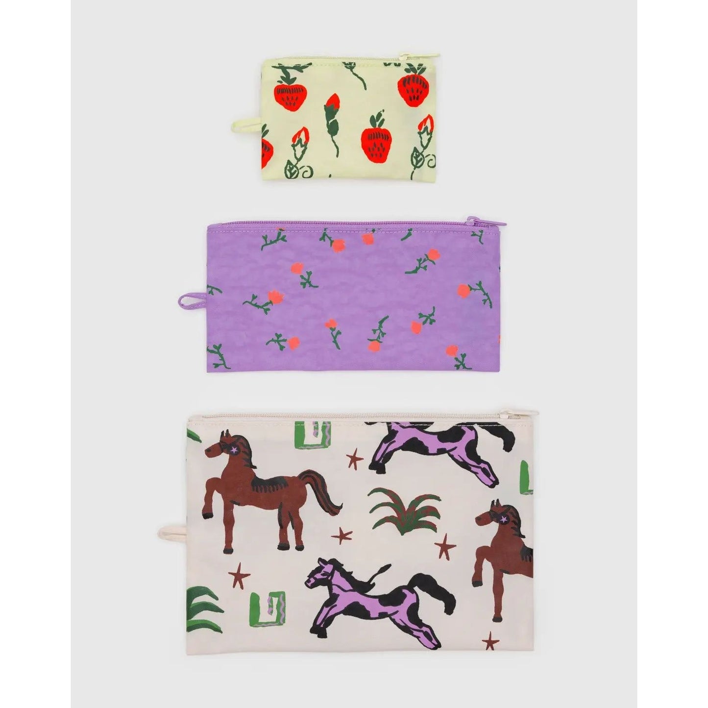 Baggu flat pouch set featuring three colorful pouches with strawberry, horse, and floral designs