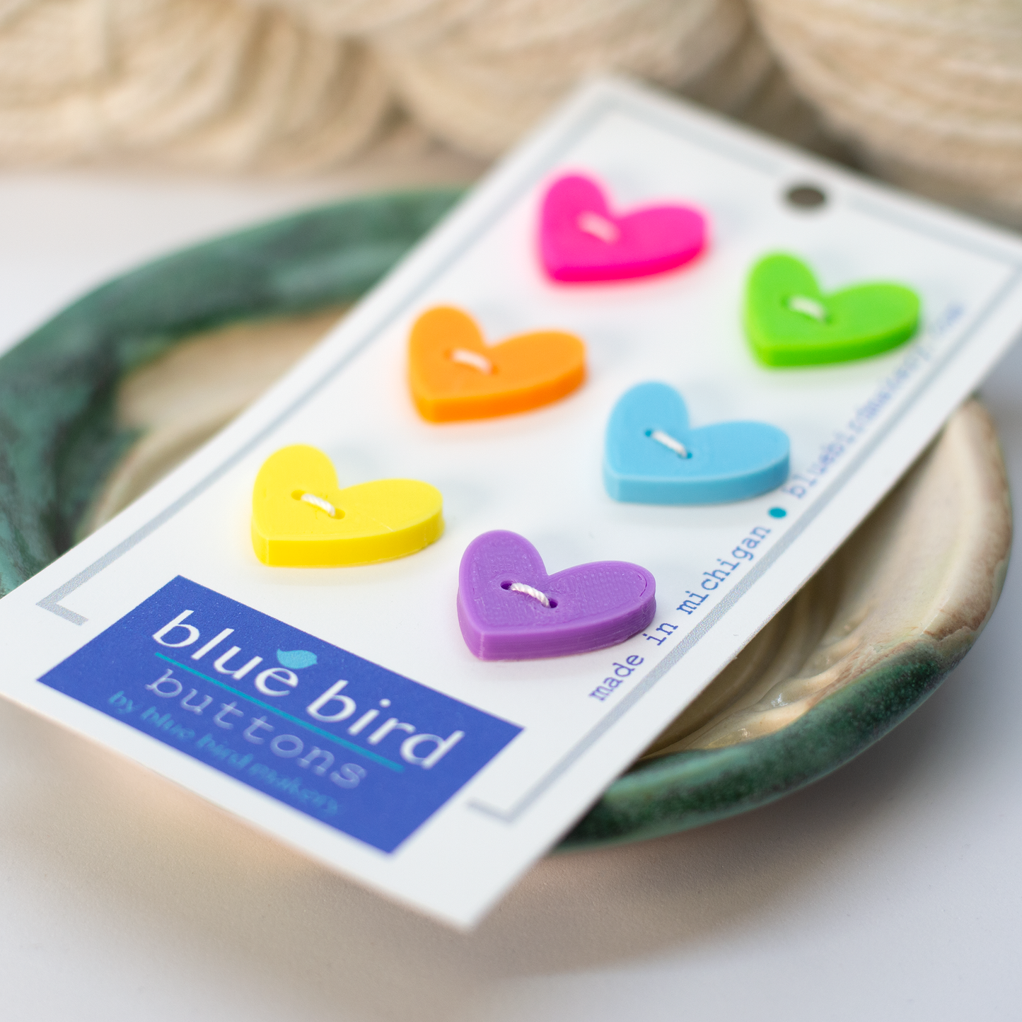 Colorful 20mm heart shaped buttons for knitting displayed on a card from Blue Bird Makery