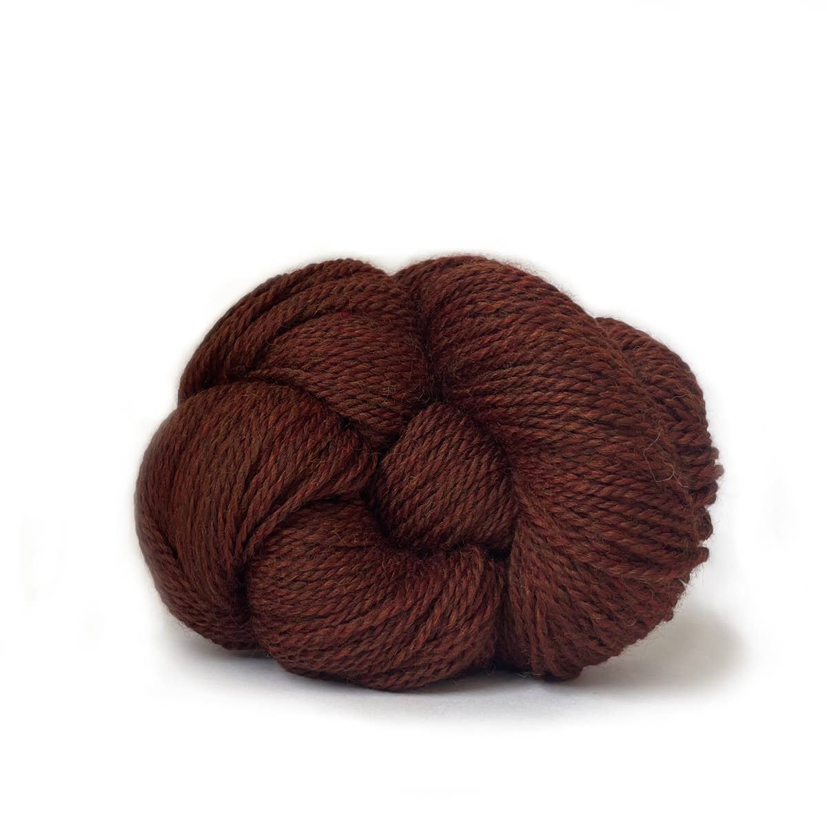 Kelbourne Woolens deep brown skein of fingering weight 100% wool yarn on white background for knitting