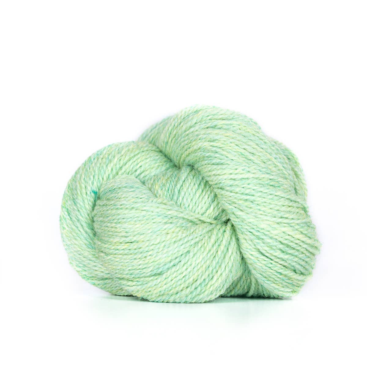 Kelbourne Woolens mint green skein on white background fingering weight 100% wool yarn for knitting