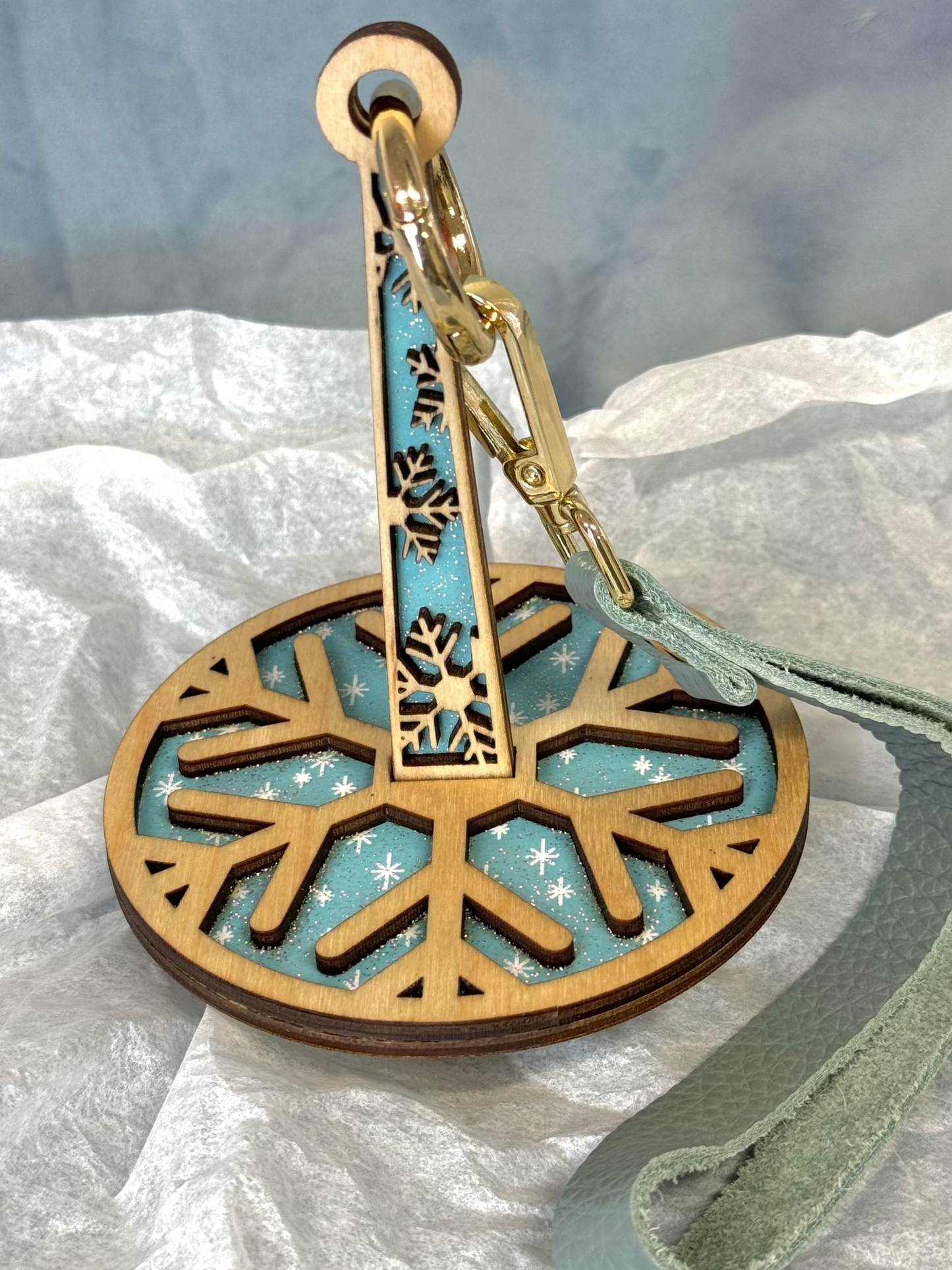 lemonwood snowflake yarn holder laser cut wood snowflake with teal fabric inlay and gold swivel clip wrist strap