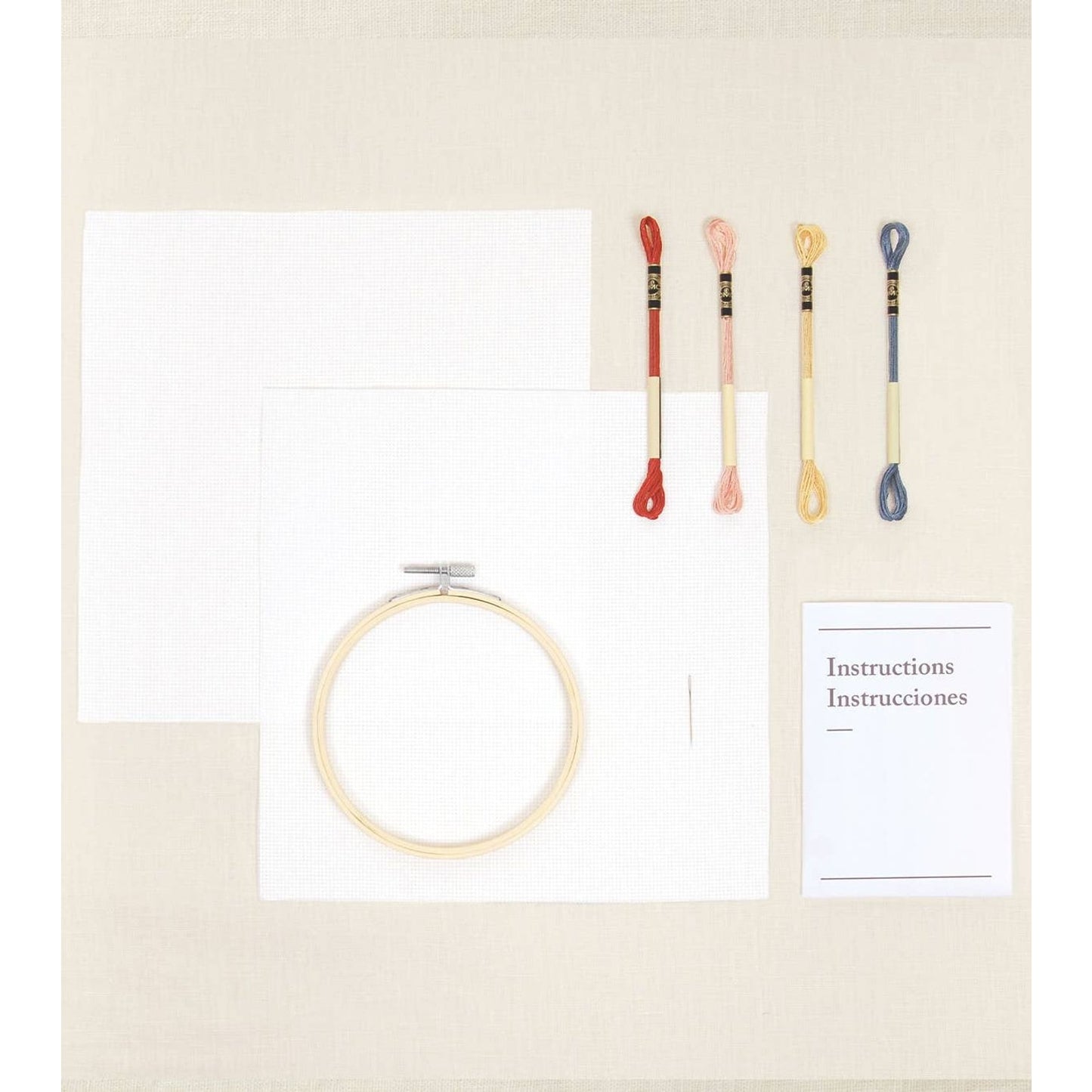 DMC cross-stitch kit featuring materials for mandala scrubs with thread, fabric, and instructions