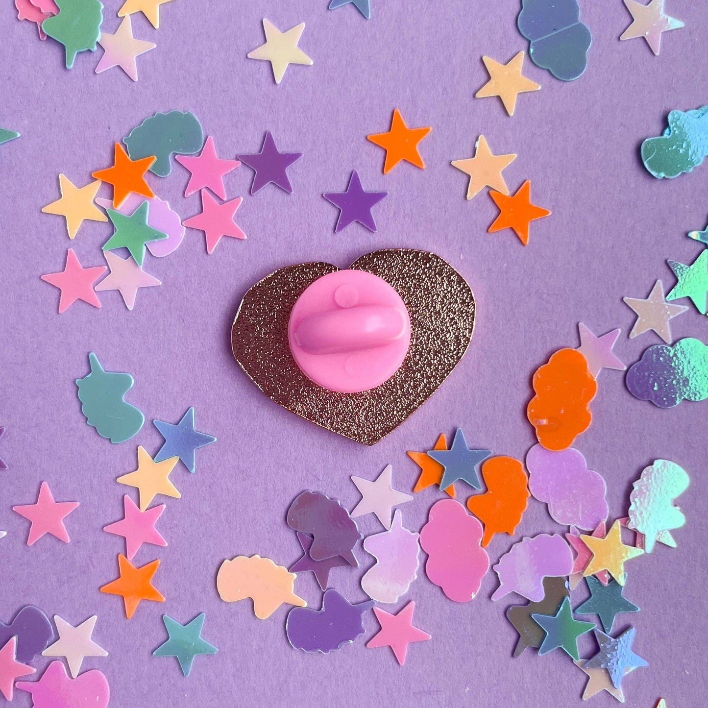 Colorful Kitty With A Cupcake enamel pin pins on a vibrant background of star-shaped confetti