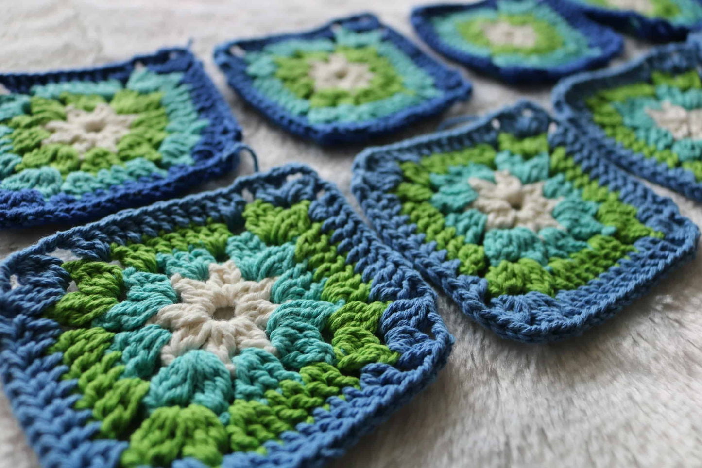 granny square crochet workshop showing blue green cream crochet squares in progress for beginner class