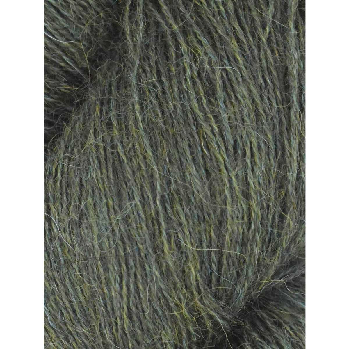 Close-up of Juniper Moon Farm Herriot yarn in a rich green hue, ideal for cozy knitting projects