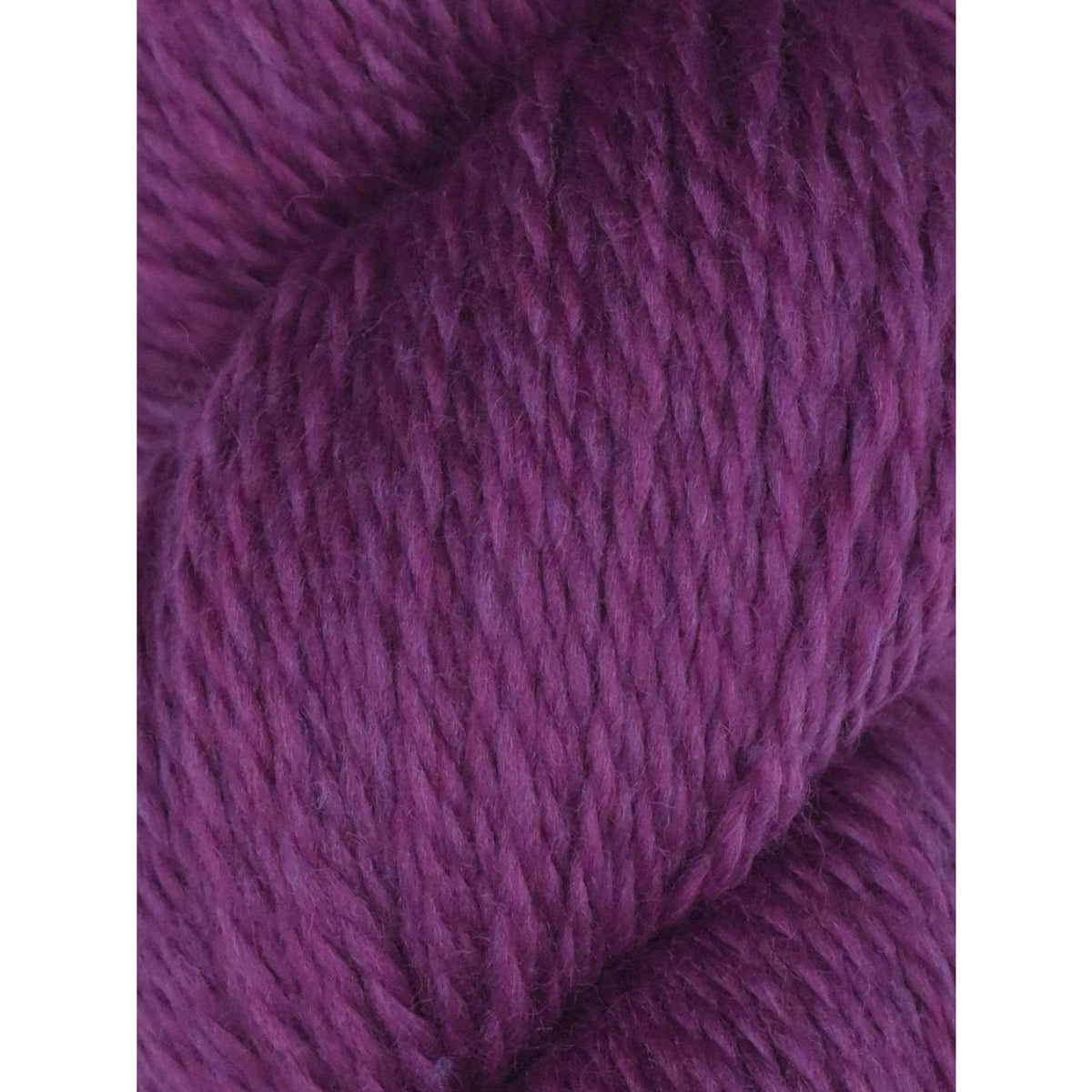 Knitting Fever purple skein close up showing soft texture and ply of Juniper Moon Farm Rambouillet yarn