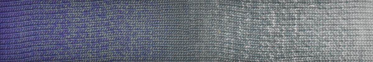 Close-up of gray textured yarn strands by Knitting Fever showcasing Laines du Nord luxury yarn