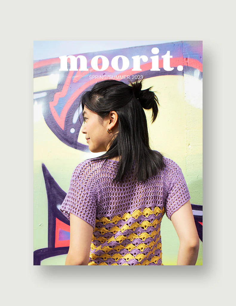 Moorit Magazine crochet patterns cover showing woman in purple and yellow crochet top against a graffiti wall