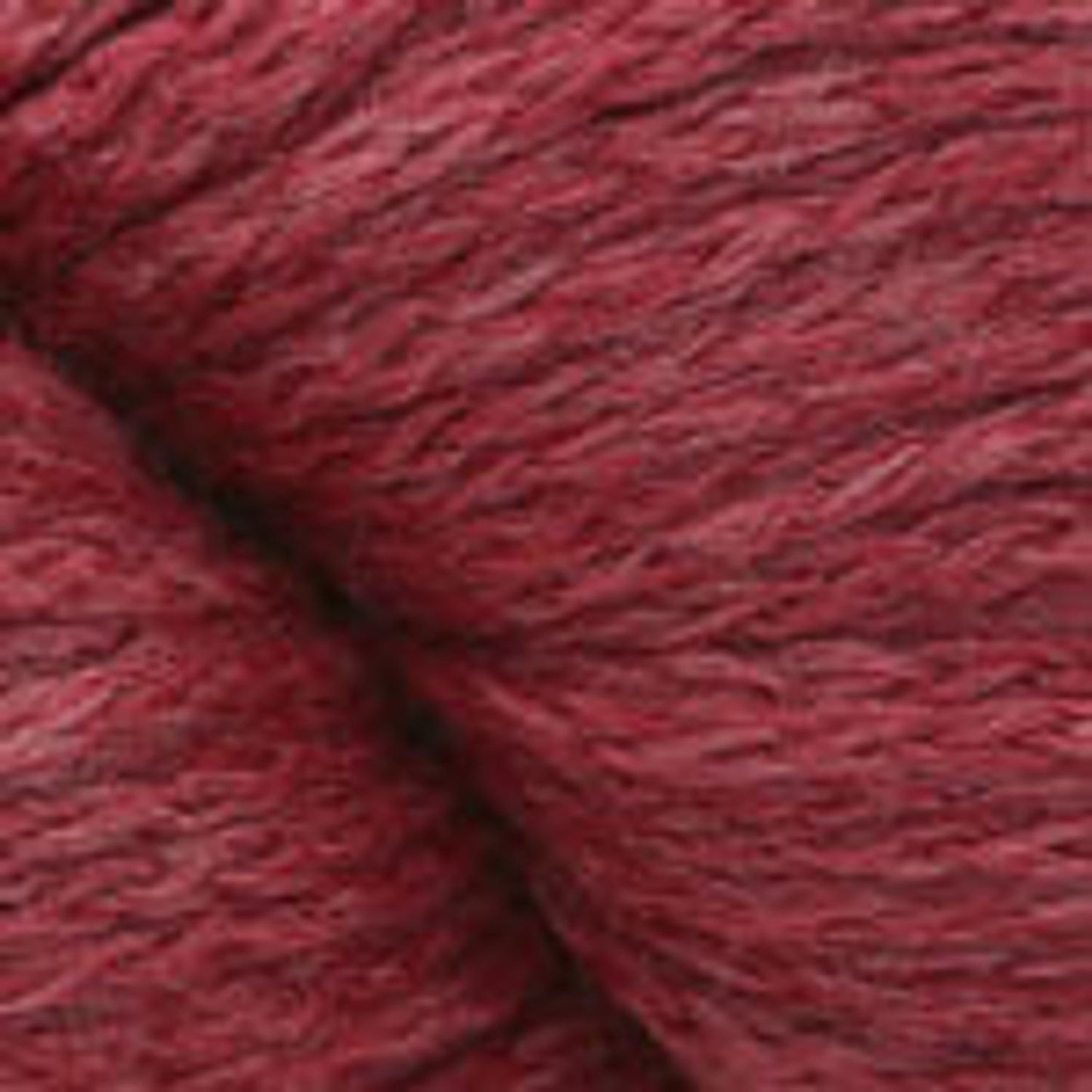 Close-up of Plymouth Yarn Viento 100 in a rich red hue, ideal for knitting and crocheting projects