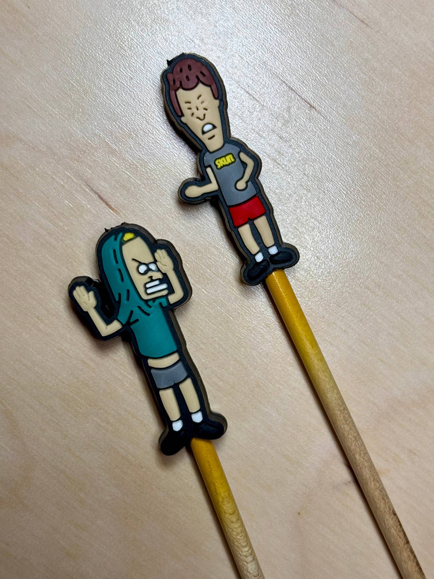 Set of two 90s cartoon knitting needle point protectors on wooden needles for stitch safety and retro craft style