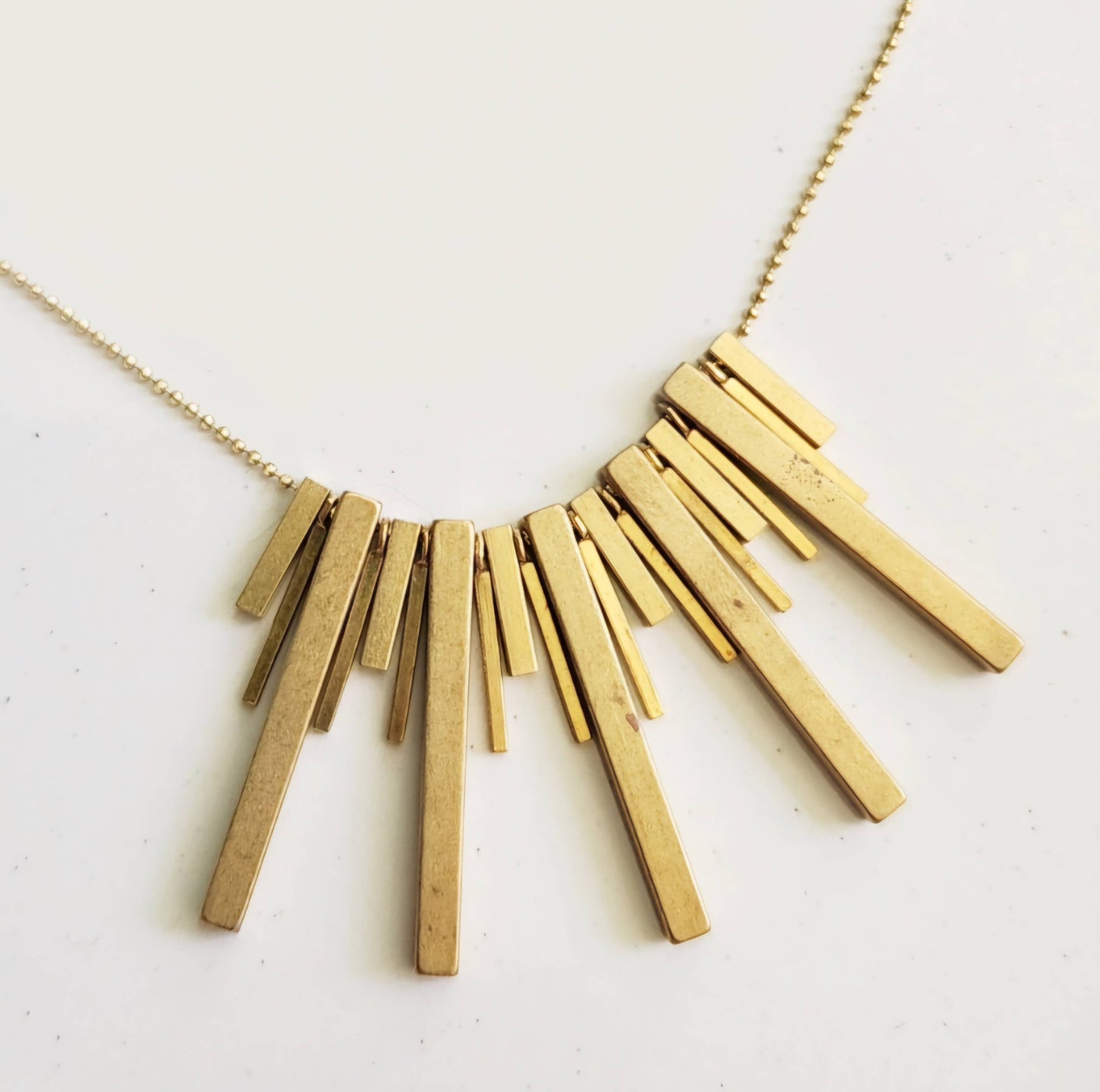 Gold bar pendant necklace by Sara Sela Jewelry featuring multiple vertical bars on delicate chain beaded edgy fashion necklace