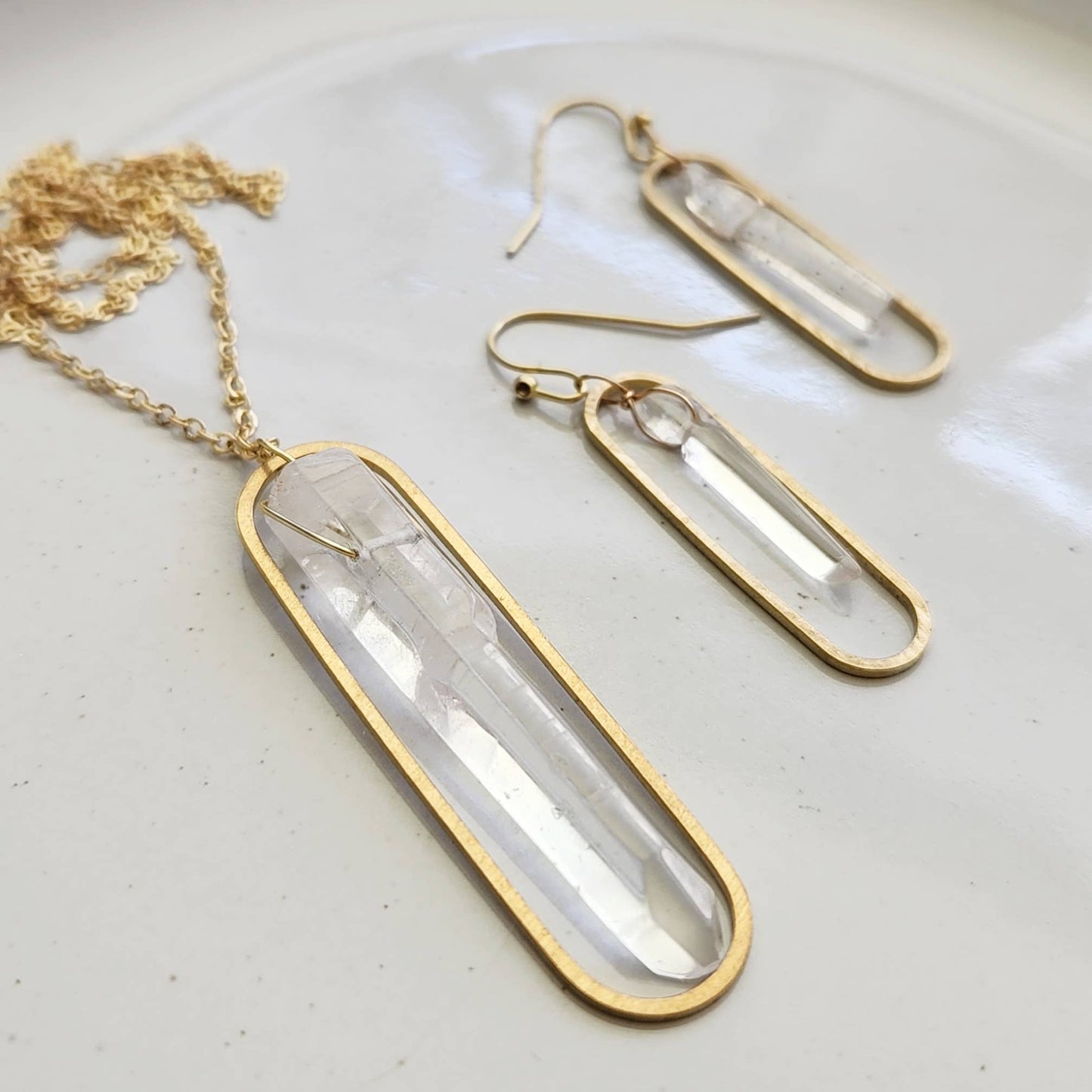 Sara Sela Jewelry gold bezel necklace and wire wrapped quartz crystal earrings with clear long quartz