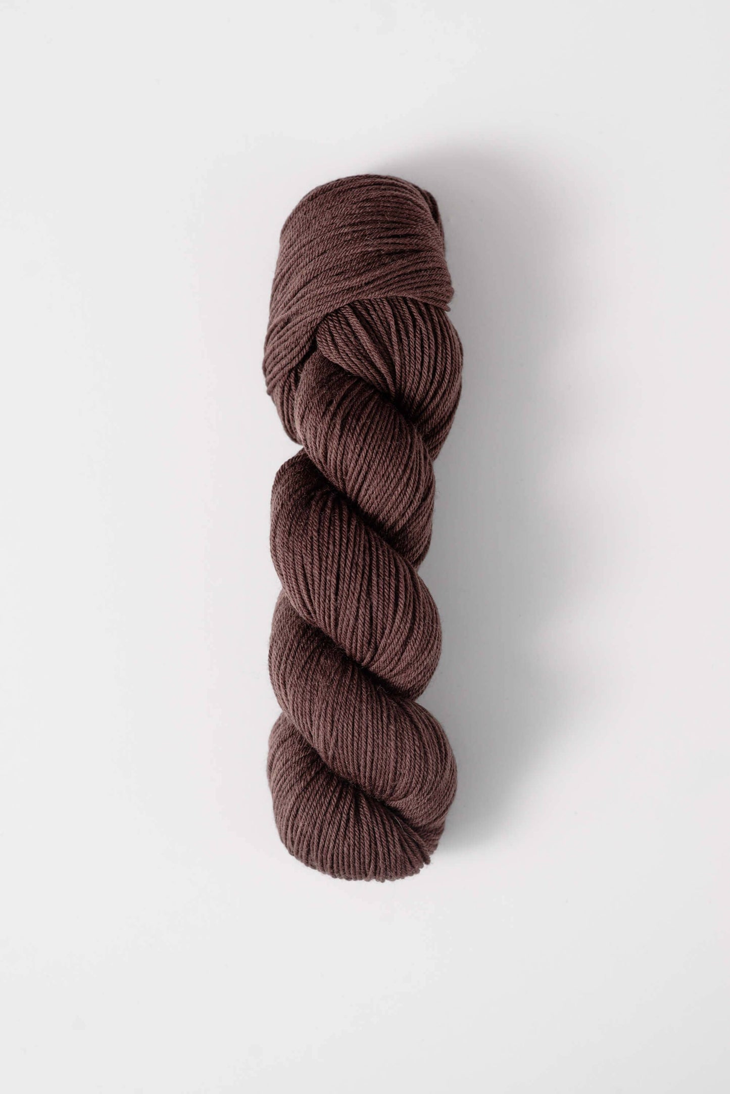 Quince and Co superwash merino fingering yarn in rich brown color skein