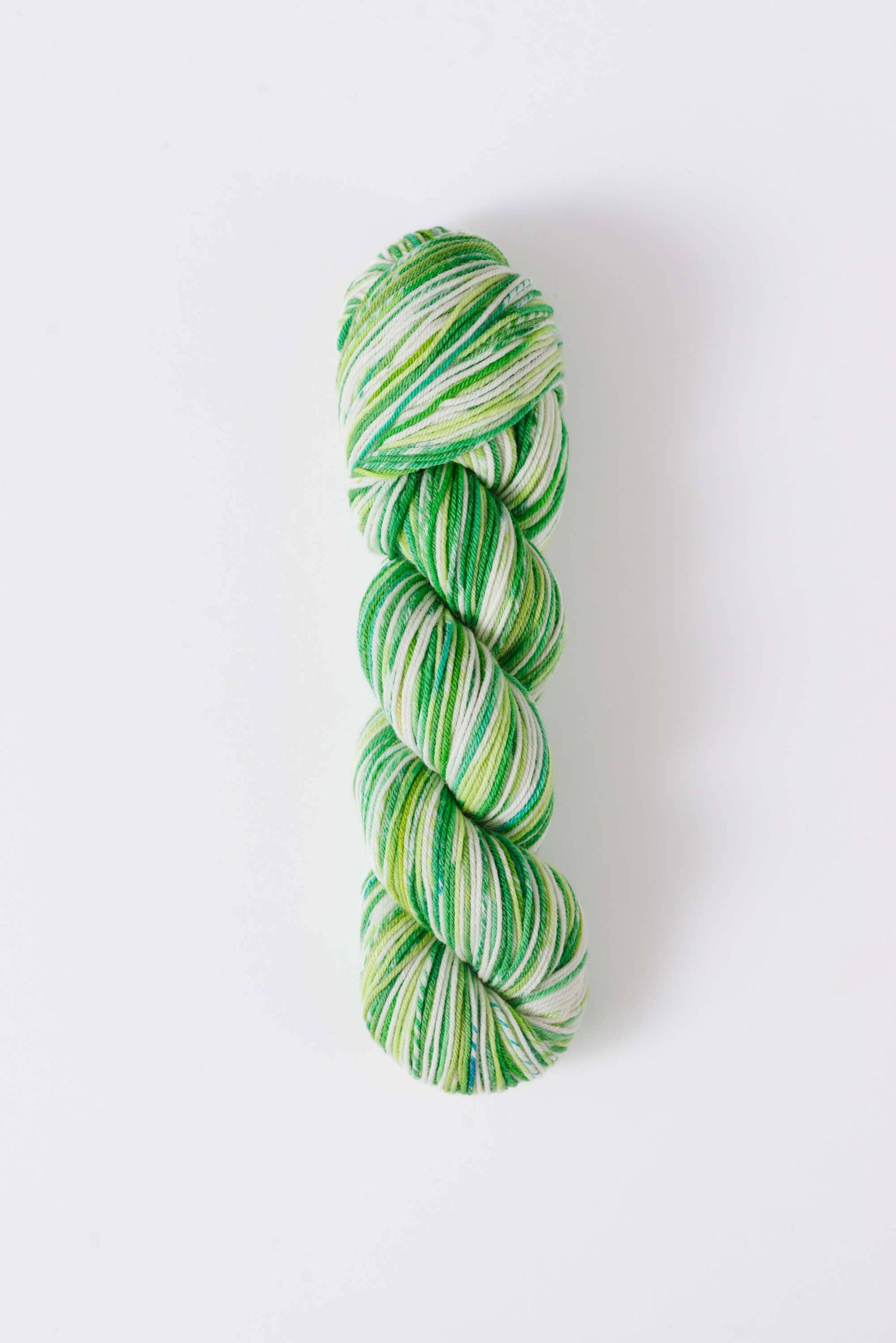 Quince & Co. green and white superwash merino fingering yarn skein for knitting and crocheting