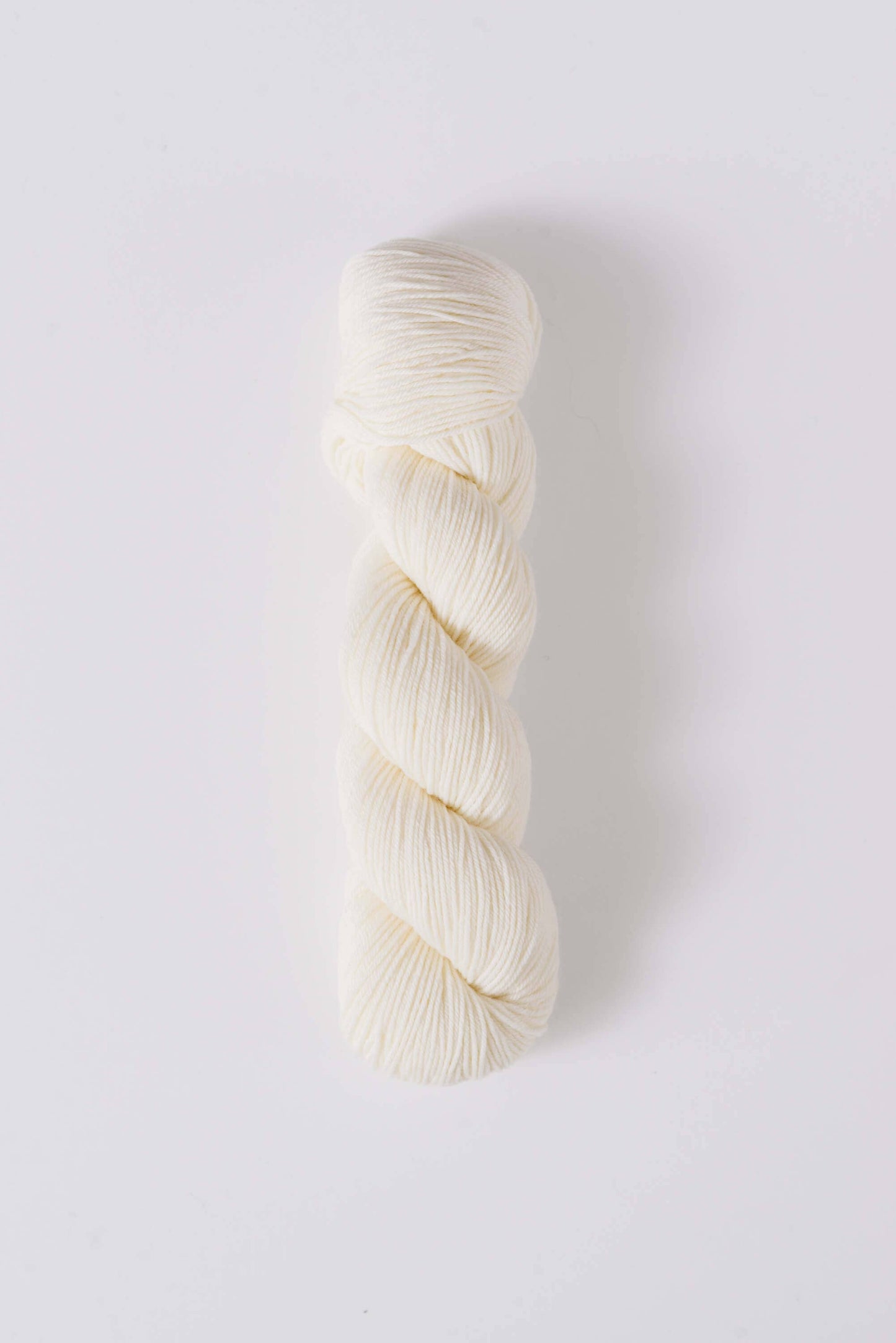 Quince & Co. white superwash merino fingering yarn skein for knitting and crochet projects
