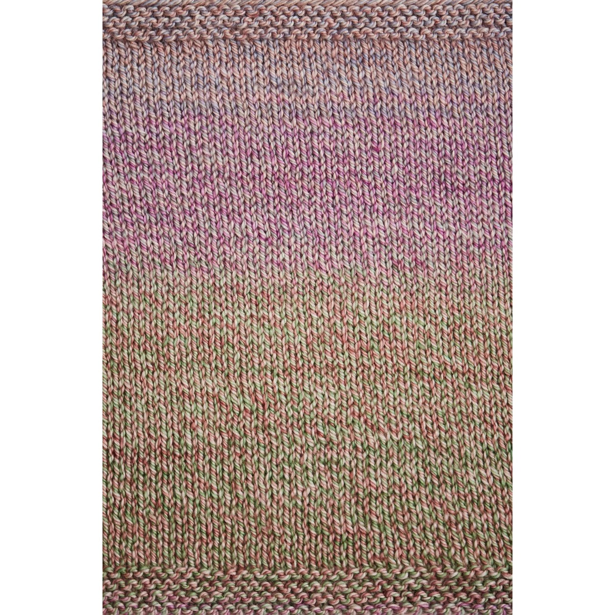 Urth Yarns Spiral Grain Light Worsted in a gradient color blend of pink and green for knitting projects