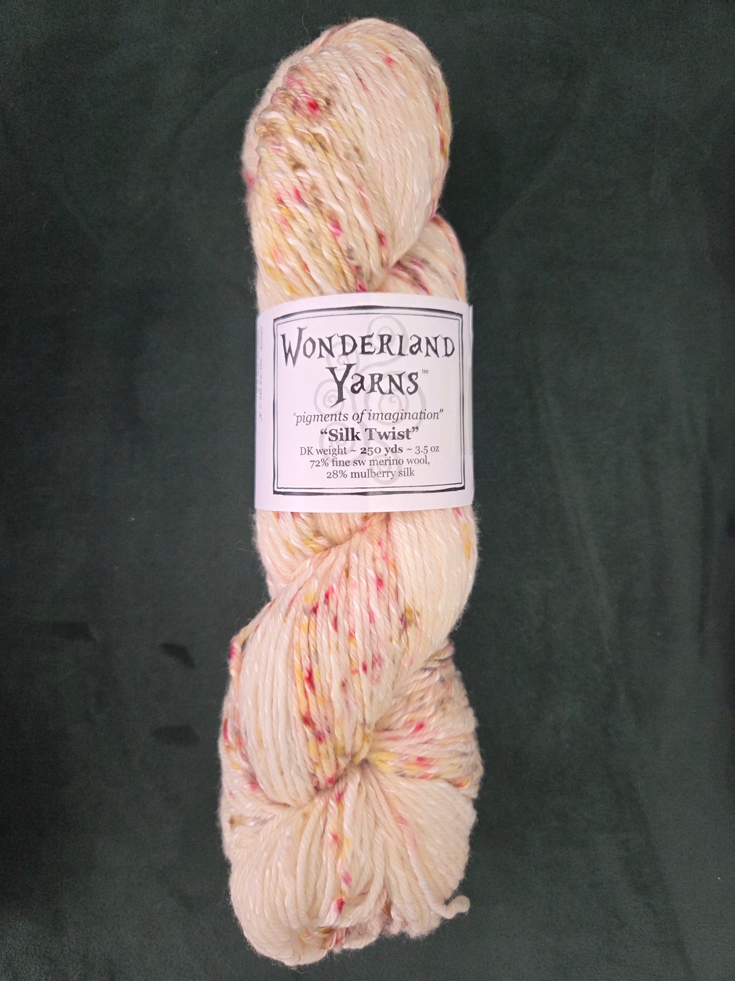 Frabjous Fibers skein of Wonderland Yarns Silk Twist hand dyed cream yarn with pink and yellow speckles
