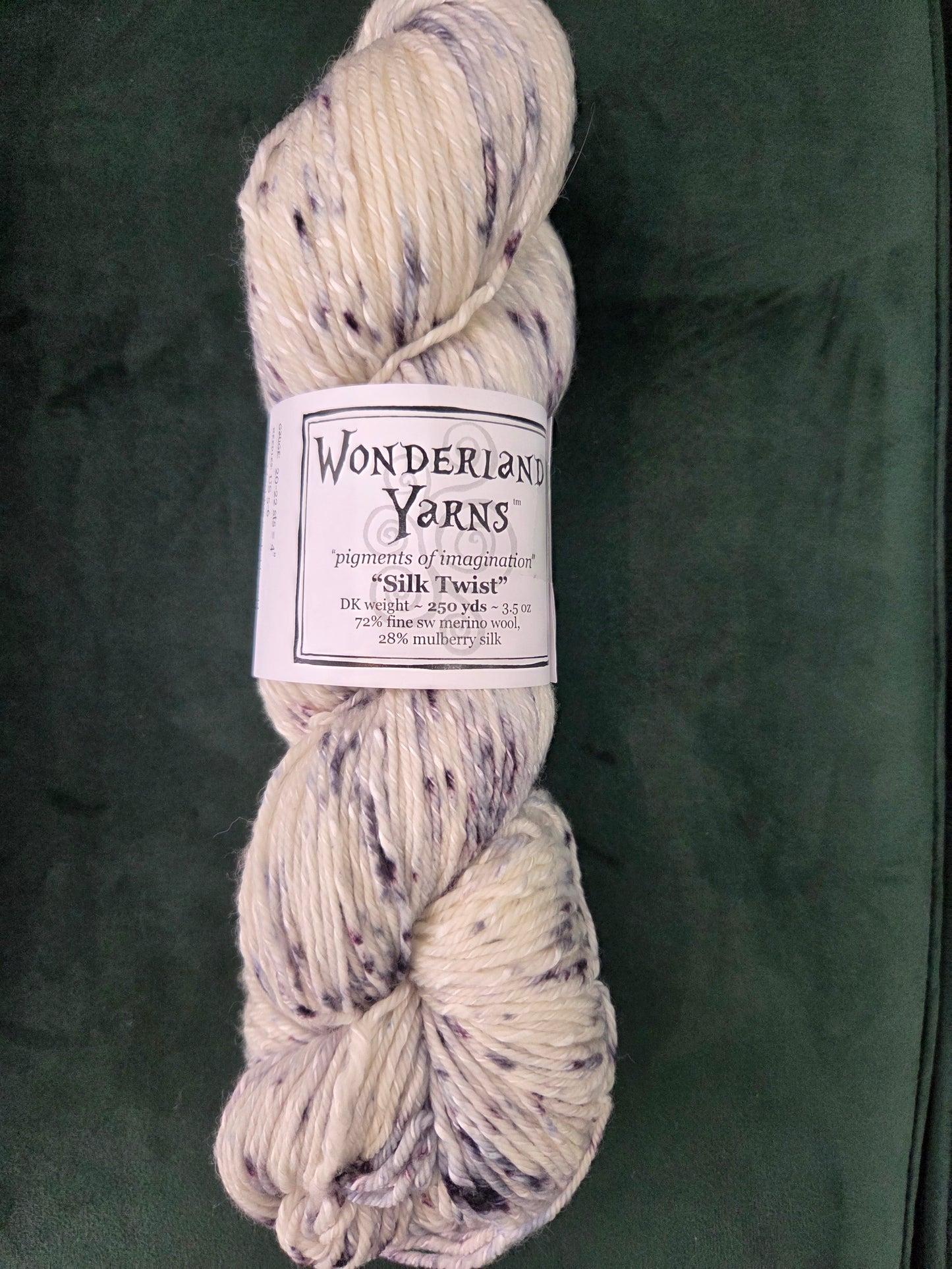 Frabjous Fibers hand dyed speckled cream and lavender skein of Wonderland Yarns Silk Twist