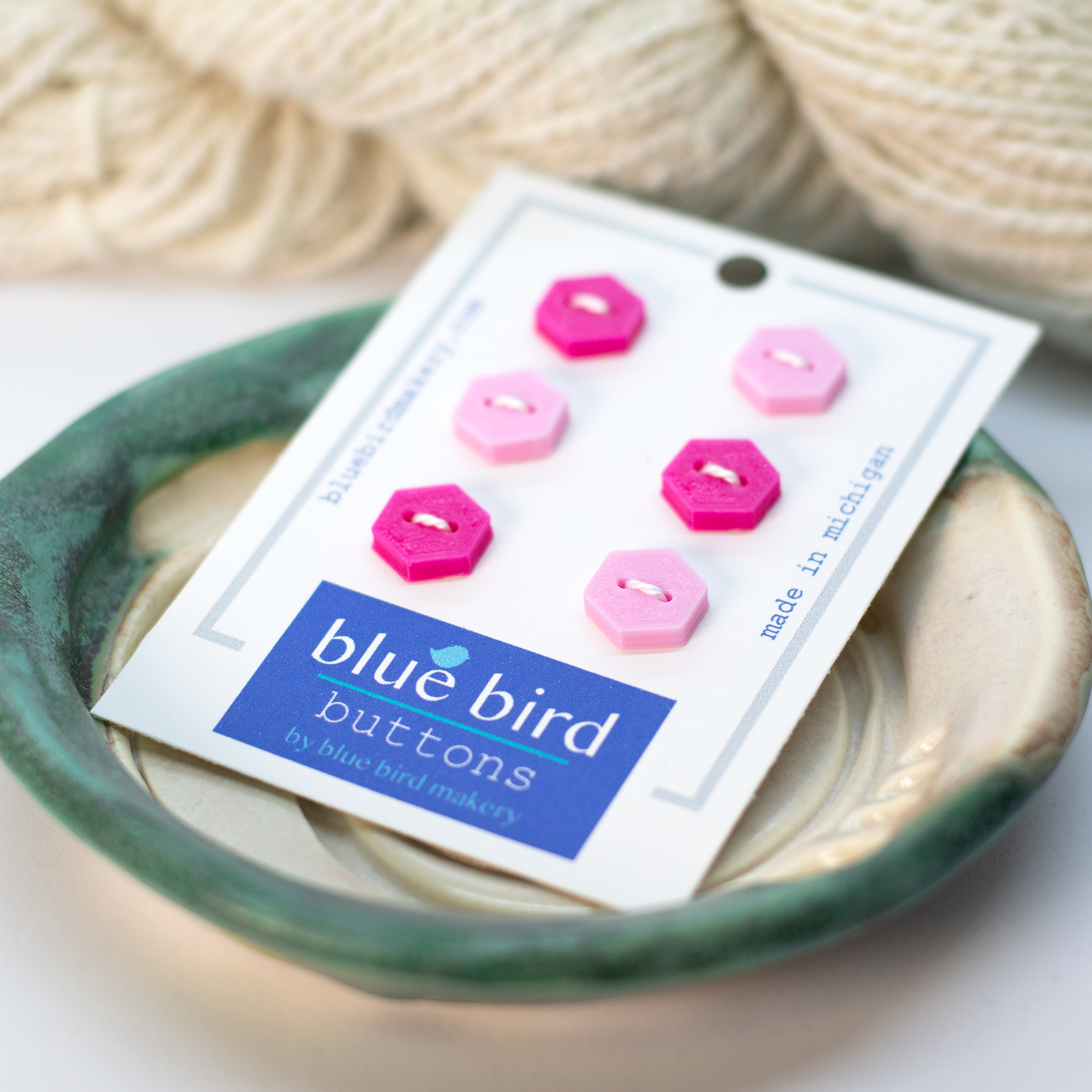 Blue Bird Makery button set featuring pink and light pink hexagon buttons on a display card