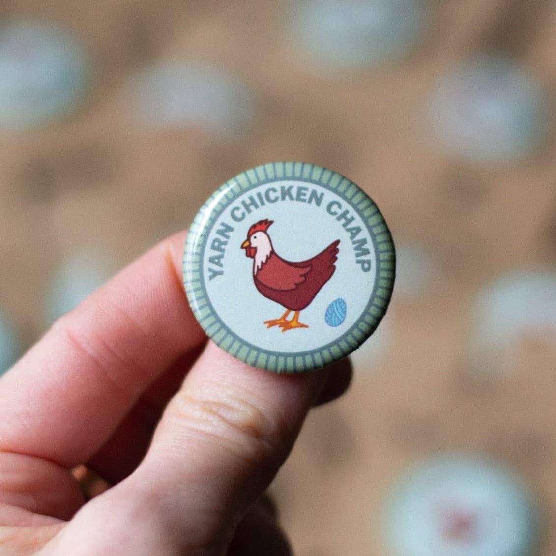 Yarn Chicken Champ Pin featuring a cartoon chicken holding yarn, perfect for yarn retailers near me