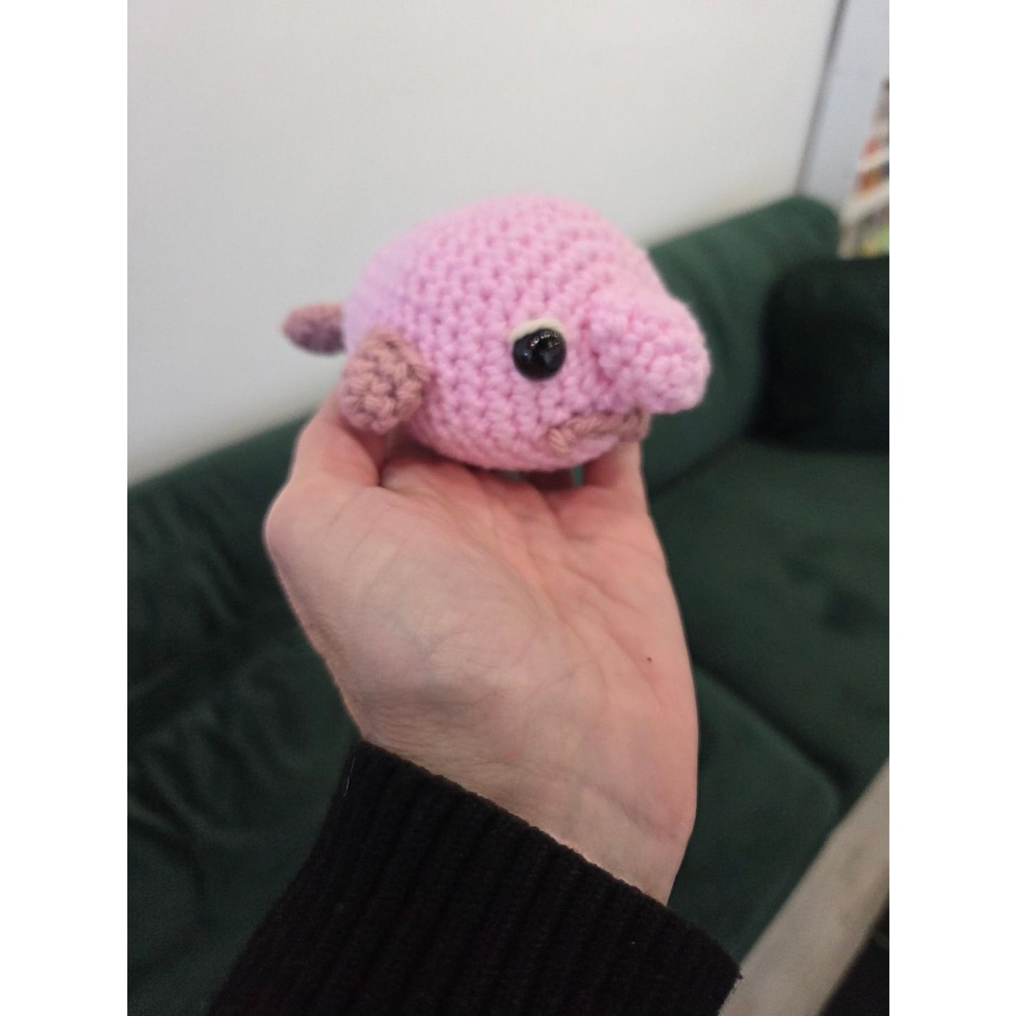 Handmade pink amigurumi toy in hand at AriYARN Shop showcasing amigurumi workshop near Chicago