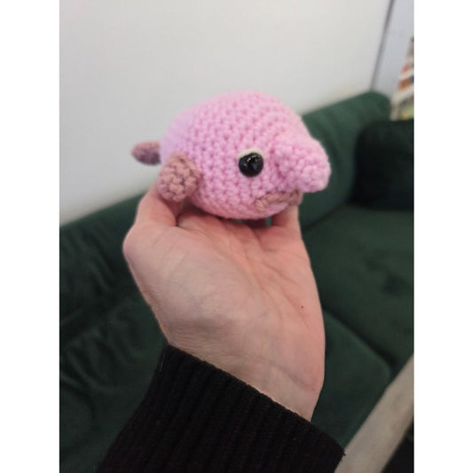 Handmade pink amigurumi toy in hand at AriYARN Shop showcasing amigurumi workshop near Chicago