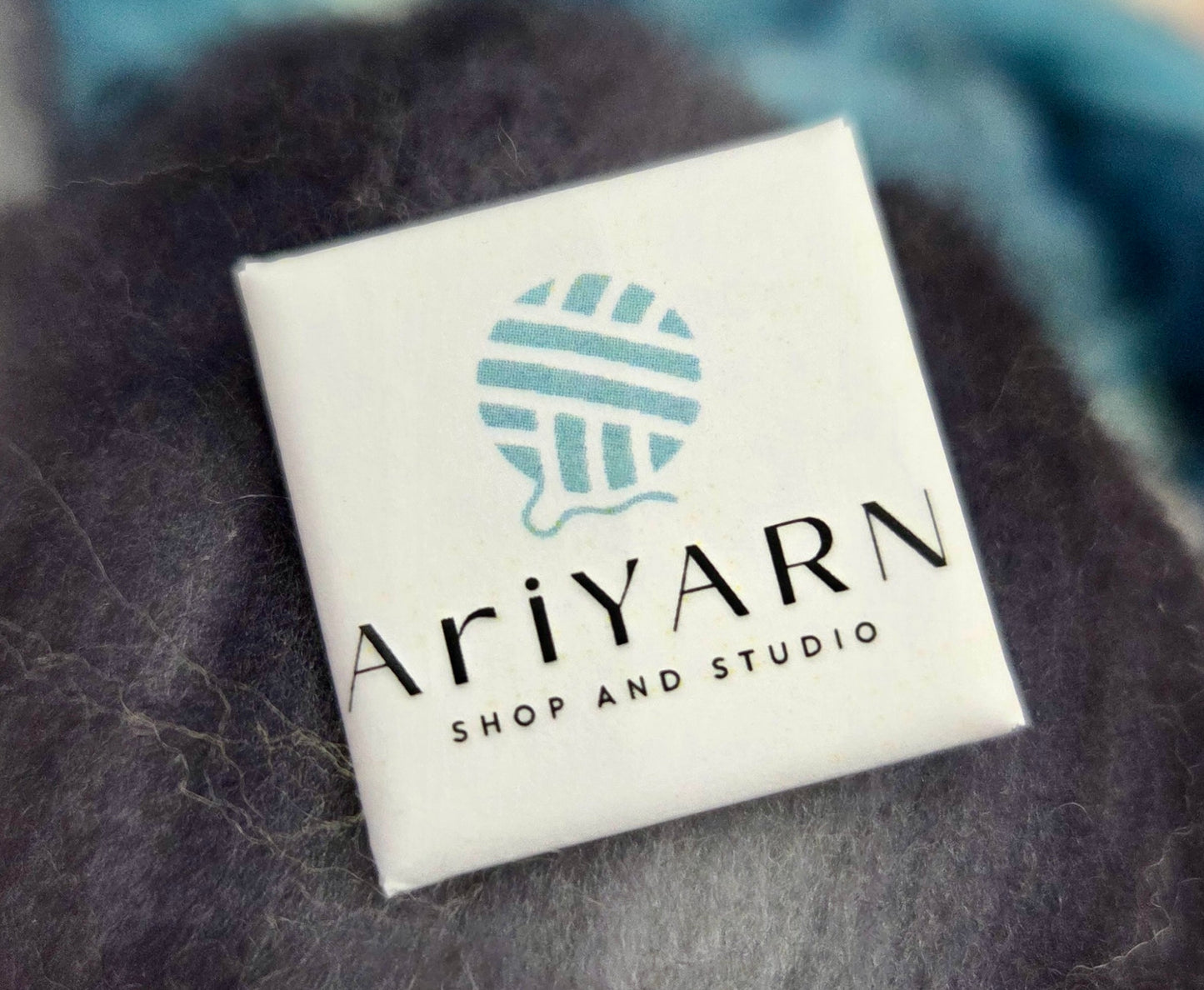 AriYARN square button featuring the AriYARN logo and design for yarn enthusiasts