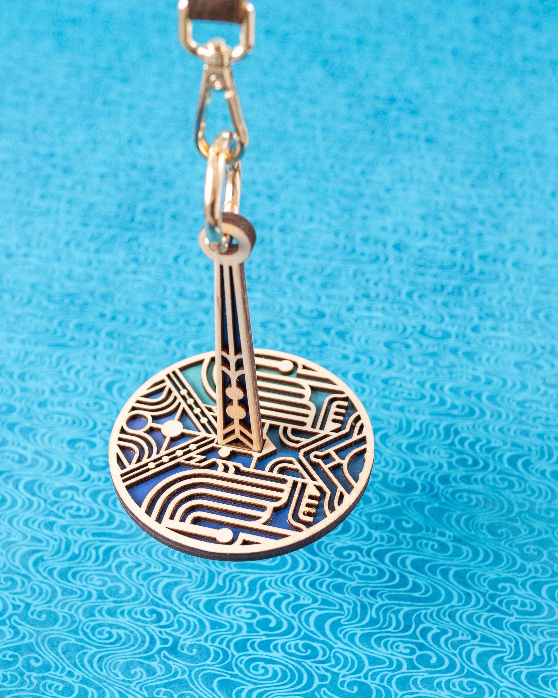 lemonwood art deco stitch marker round laser cut wooden pendant with blue enamel backing and clasp for knitting