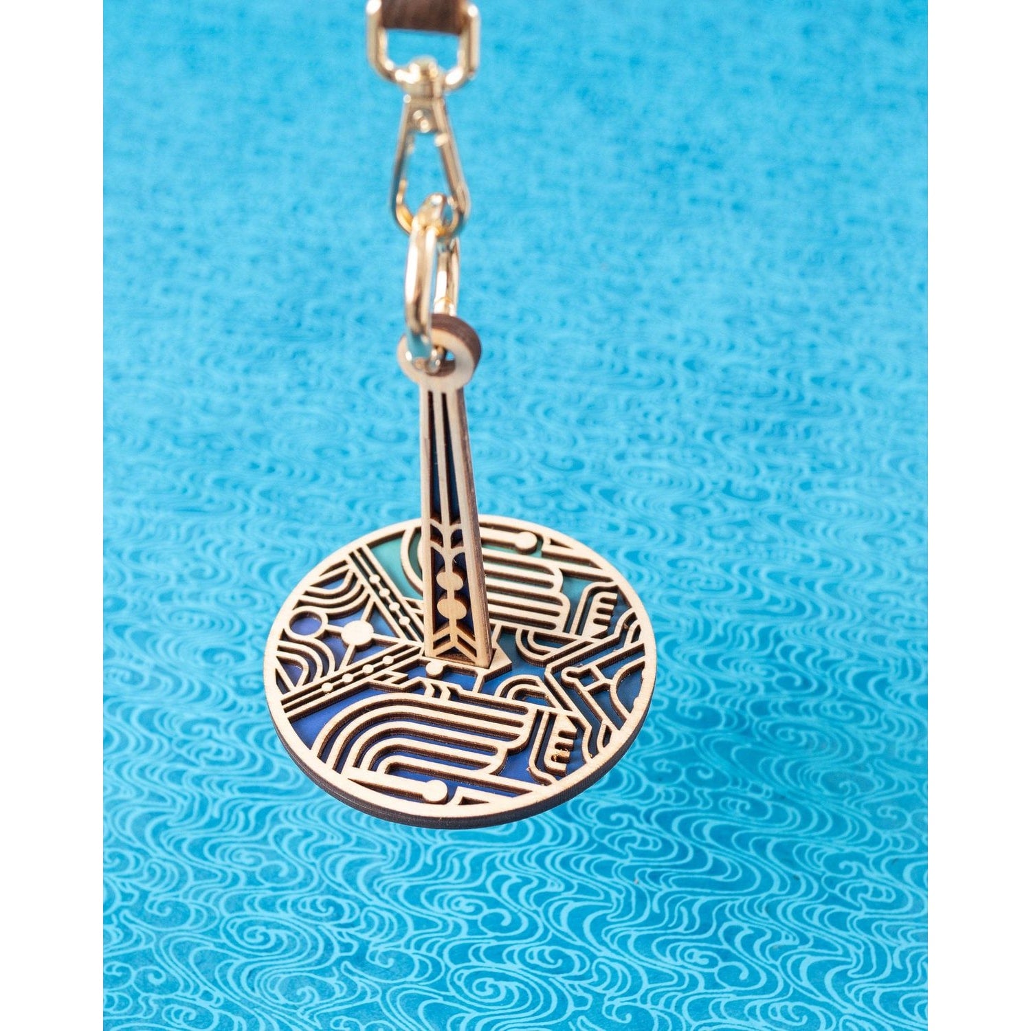 lemonwood art deco stitch marker round laser cut wooden pendant with blue enamel backing and clasp for knitting