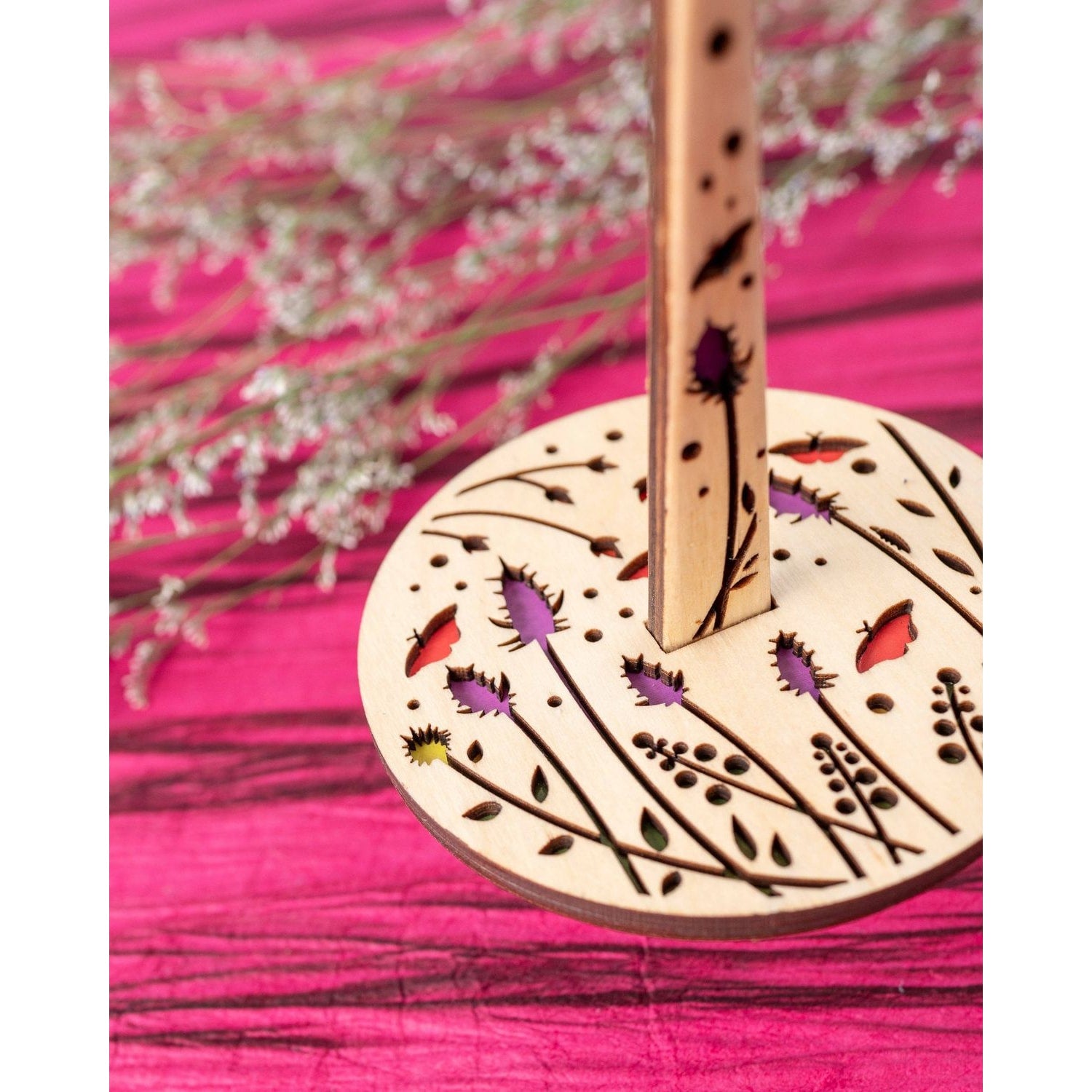 lemonwood knitting accessory wooden spindle with laser cut floral design and colorful inlays on pink background