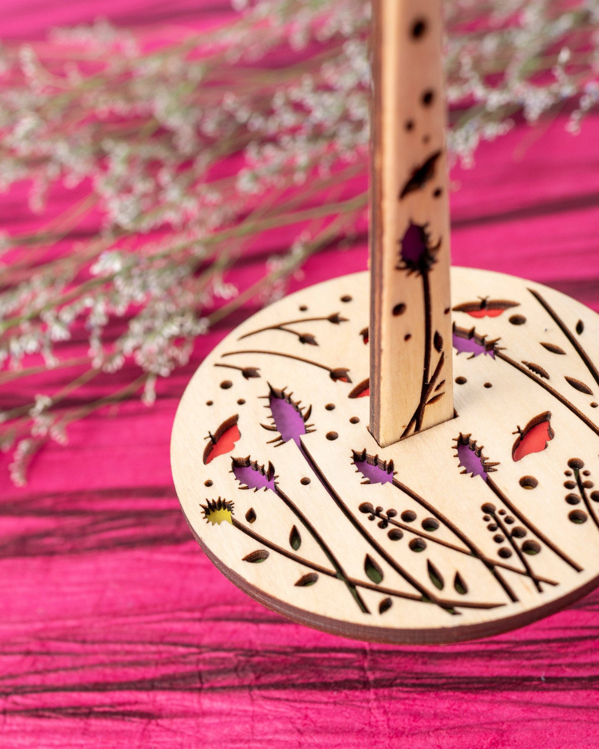lemonwood knitting accessory wooden spindle with laser cut floral design and colorful inlays on pink background
