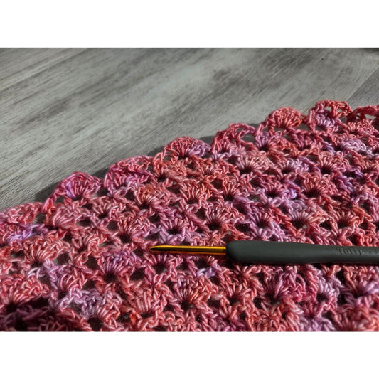 Ergonomic crochet hook on pink variegated shell stitch swatch for private crochet teacher Chicago area lessons