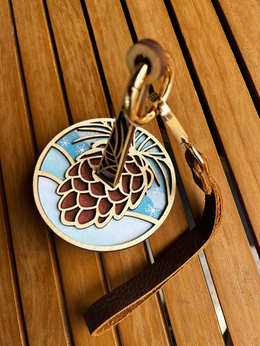 Lemonwood wooden pinecone knitting accessory keychain with layered wood pinecone design and leather strap