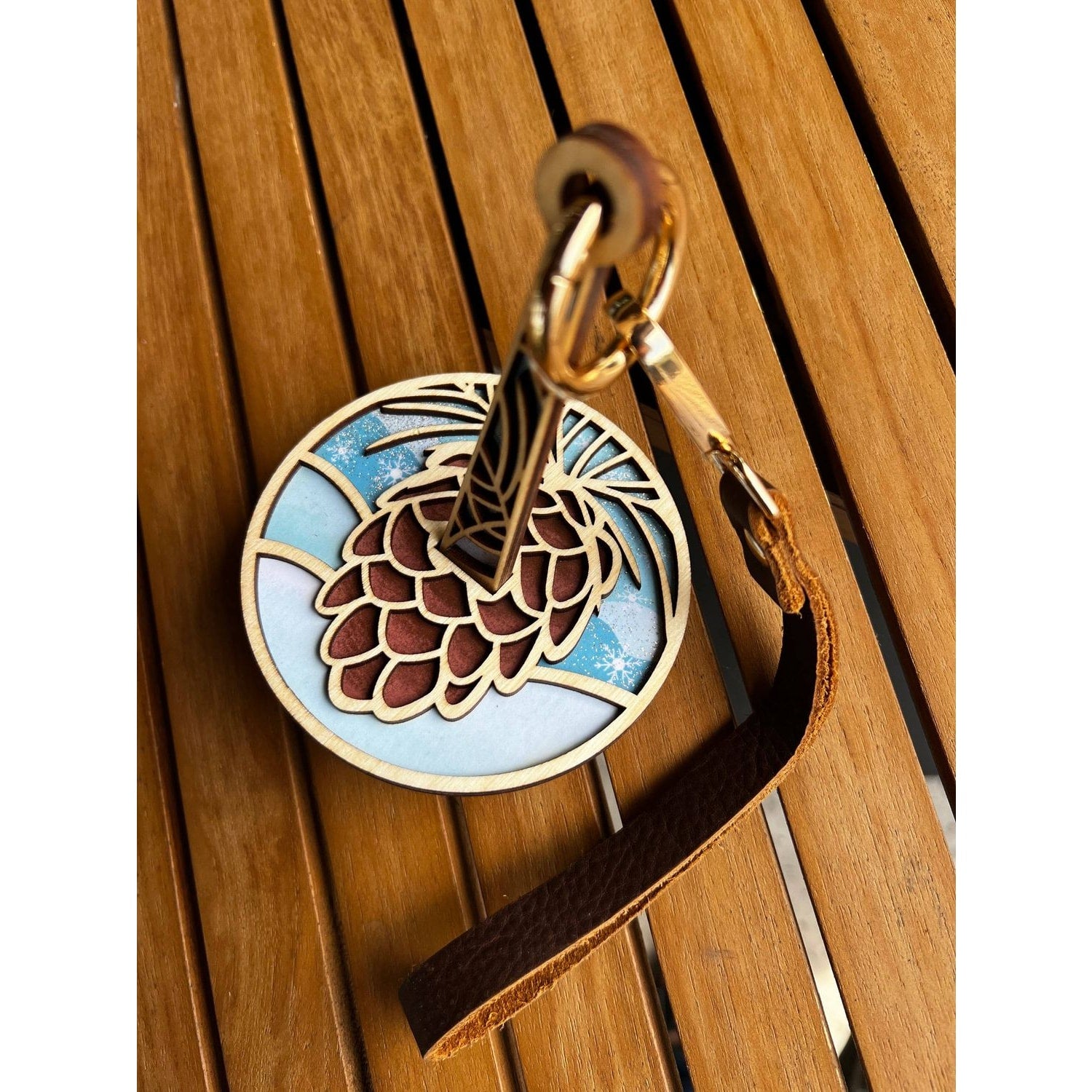 Lemonwood wooden pinecone knitting accessory keychain with layered wood pinecone design and leather strap