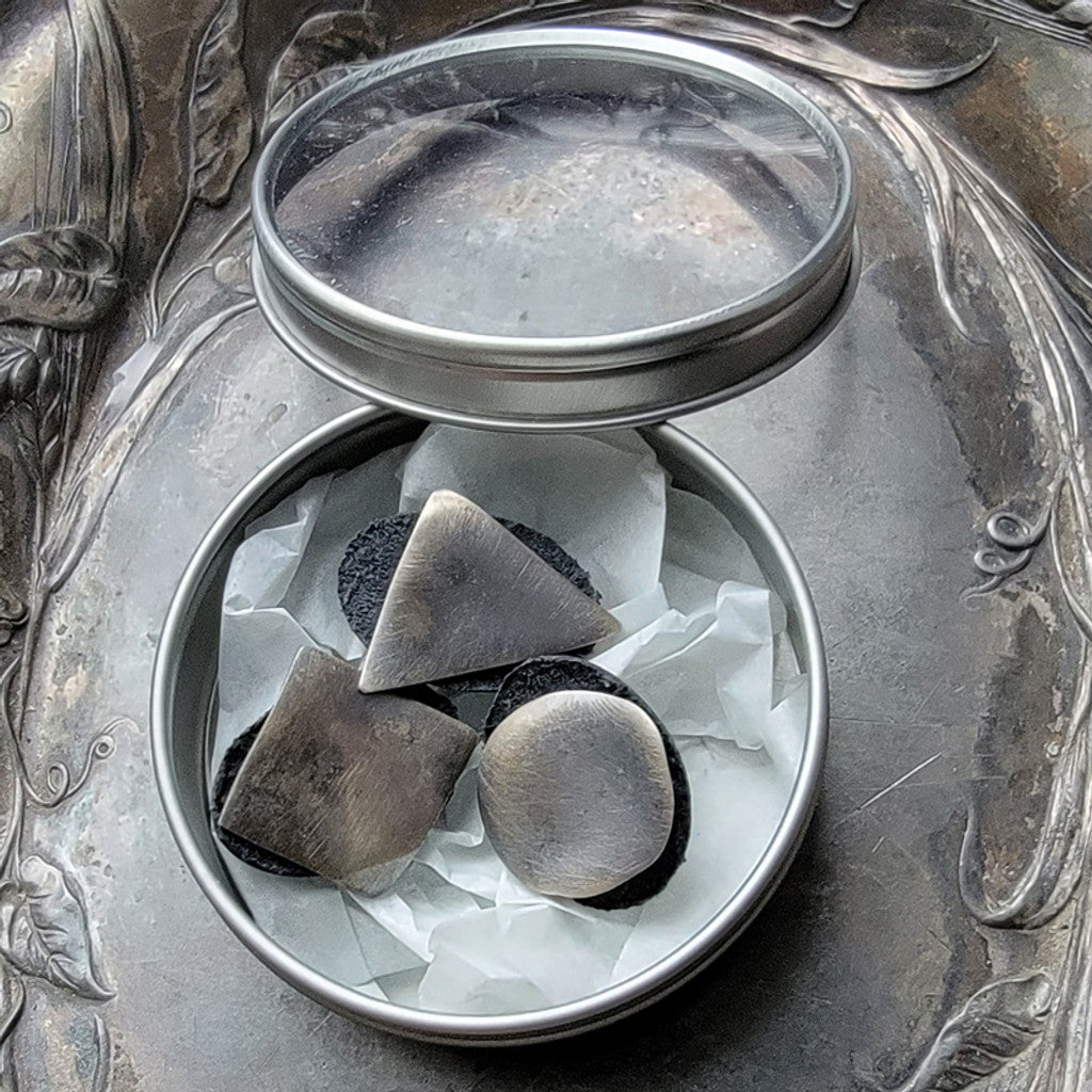 Jul Designs midcentury modern stud buttons in a silver tin showing brushed metal triangle circle and square studs