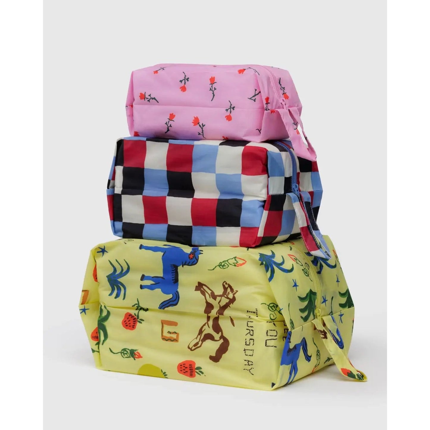 Baggu 3D Zip Set in vibrant designs, featuring pink, checkered, and playful printed bags for versatile storage