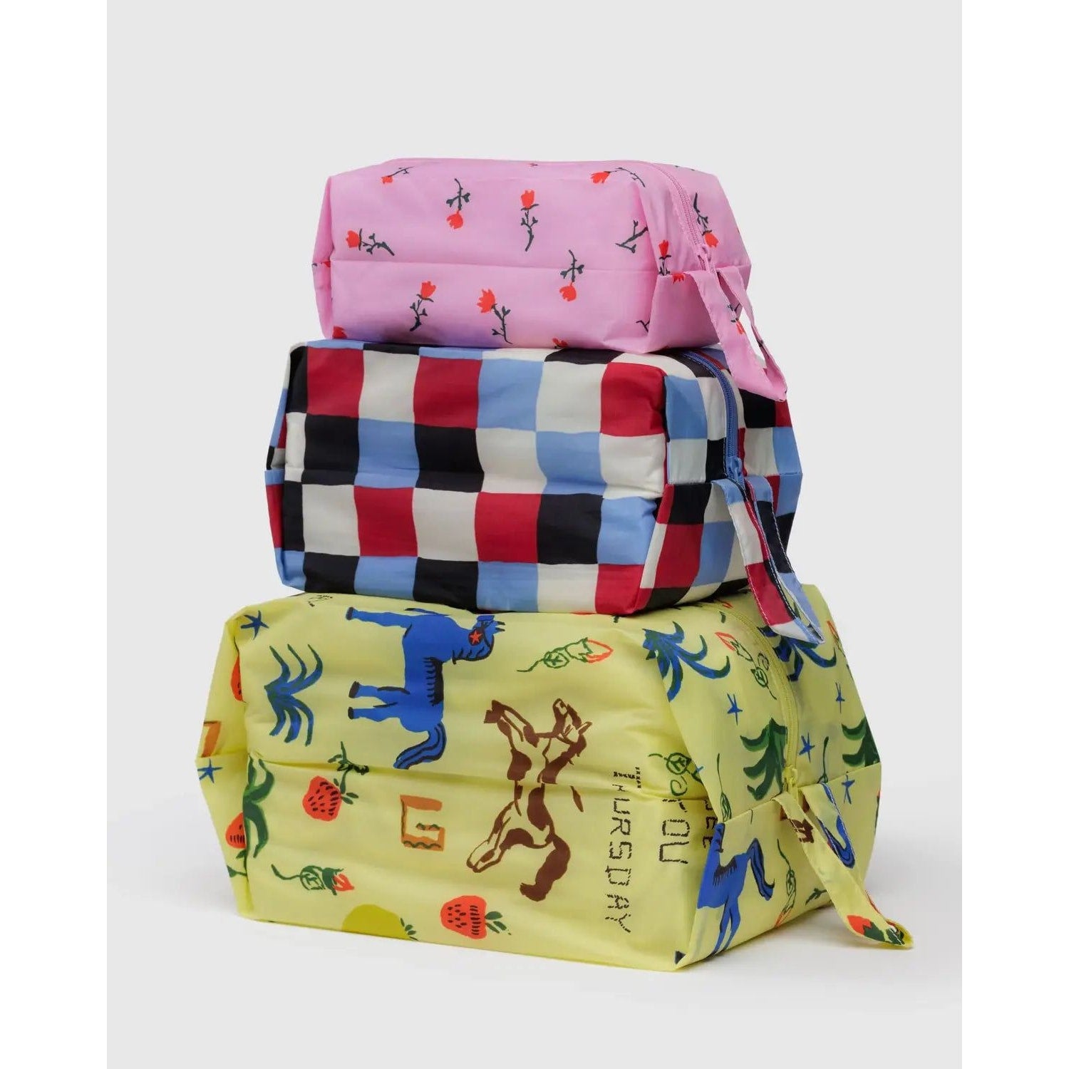 Baggu 3D Zip Set in vibrant designs, featuring pink, checkered, and playful printed bags for versatile storage
