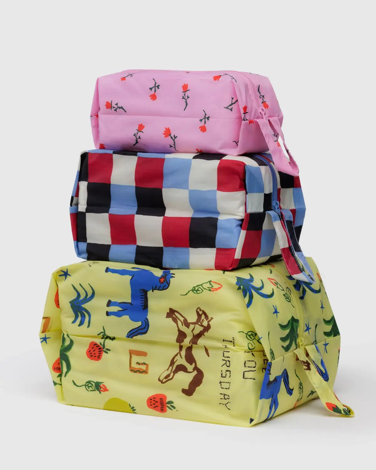 Baggu 3D Zip Set in vibrant designs, featuring pink, checkered, and playful printed bags for versatile storage