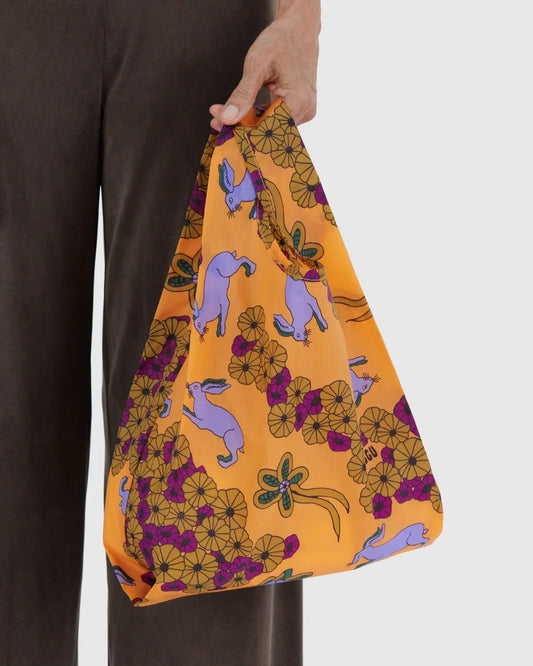 Baby Baggu reusable bag in vibrant orange with playful bunny and floral pattern, ideal for shopping