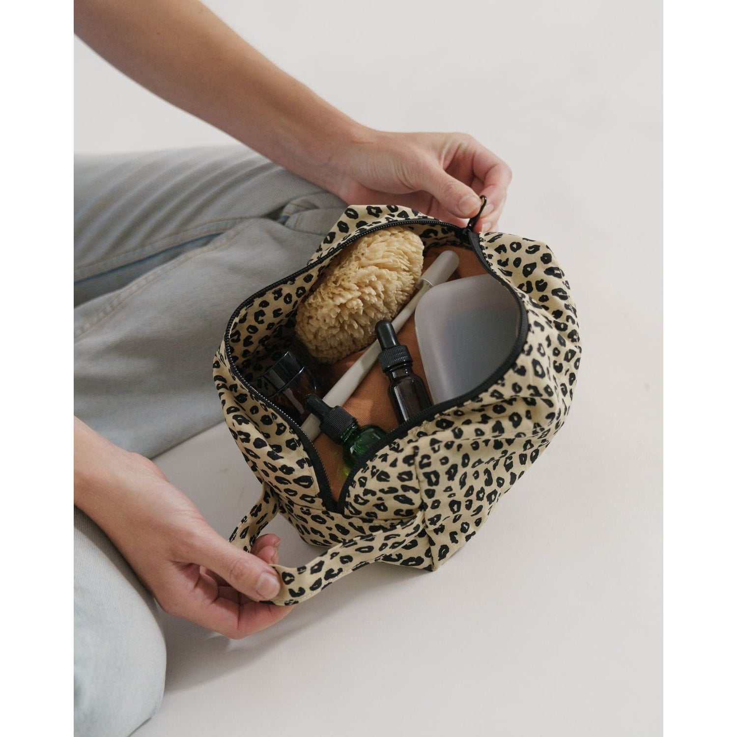 Baggu Dopp Kit in leopard print, showcasing organized skincare and grooming essentials inside