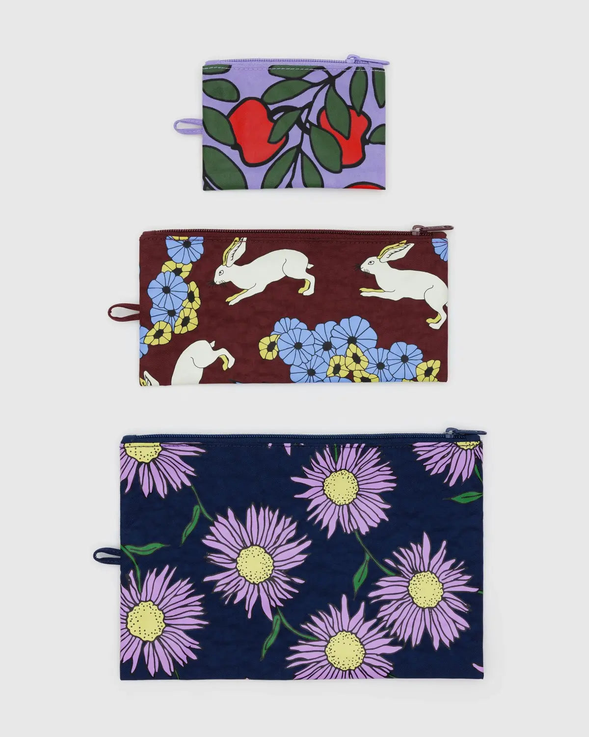 Baggu flat pouch set featuring three colorful pouches with floral and animal designs for versatile storage