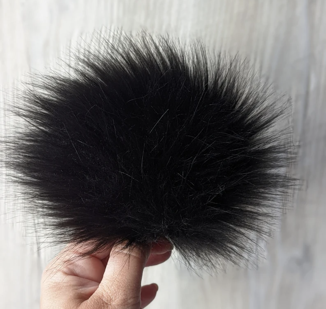 Black faux fur pom pom for hats, offering a soft and stylish accent for winter accessories