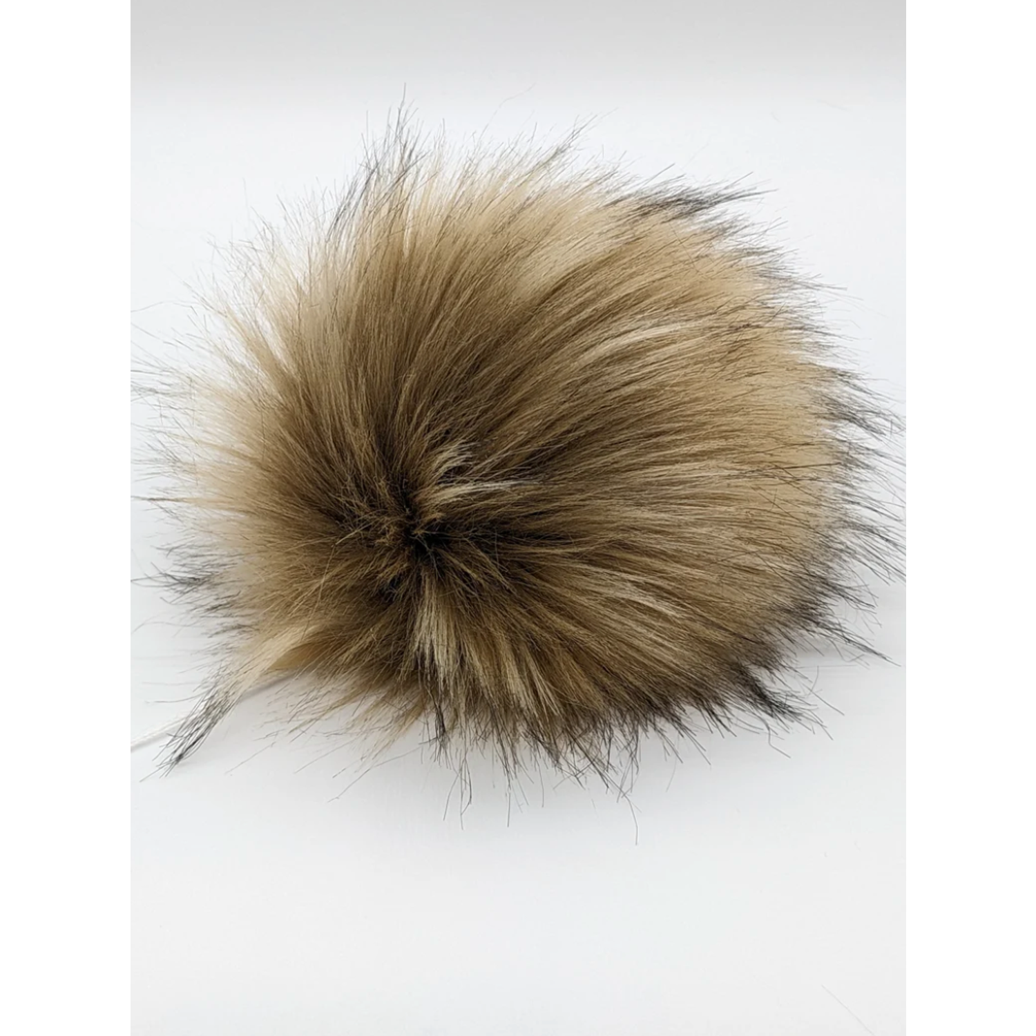 Blonde faux fur pom pom accessory perfect for adding a stylish touch to hats or bags