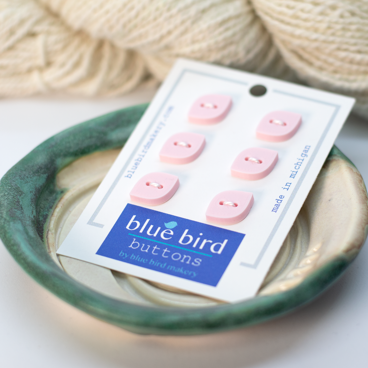 Pack of 6 pink 12mm blue bird buttons displayed in a decorative bowl