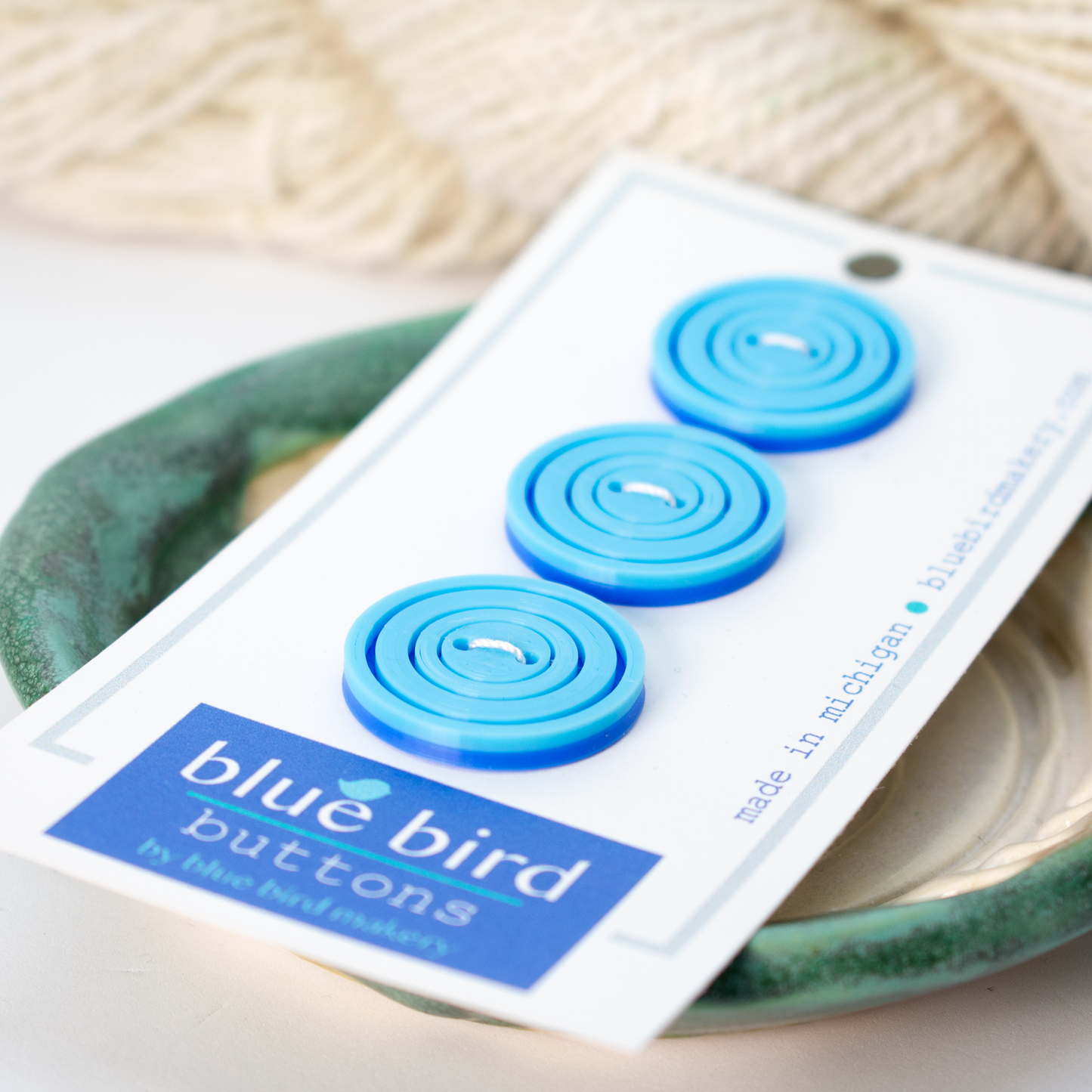 Set of three blue bird makery buttons in various blue shades, made in Michigan