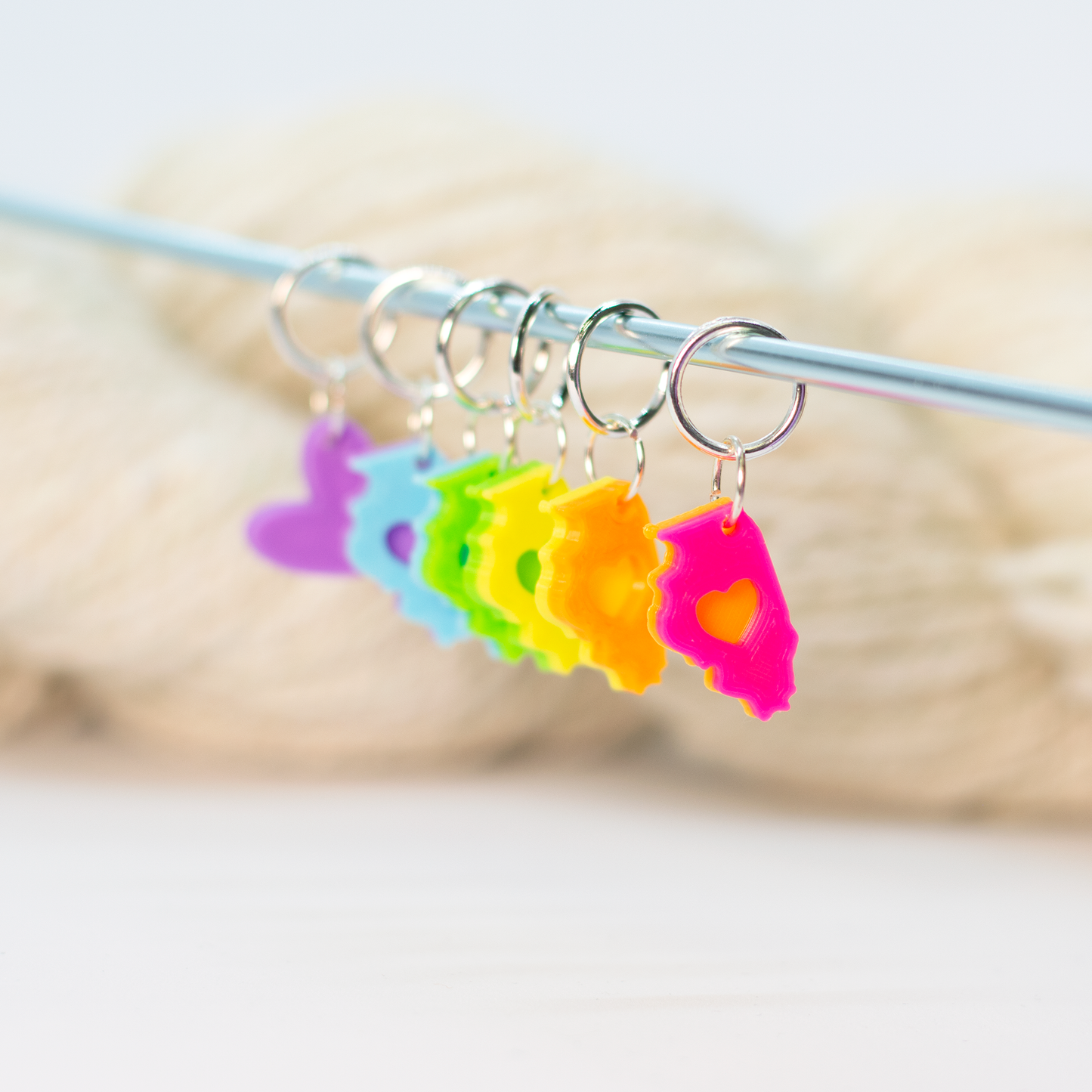 Colorful Blue Bird Makery stitch marker set in various shapes, perfect for knitting projects
