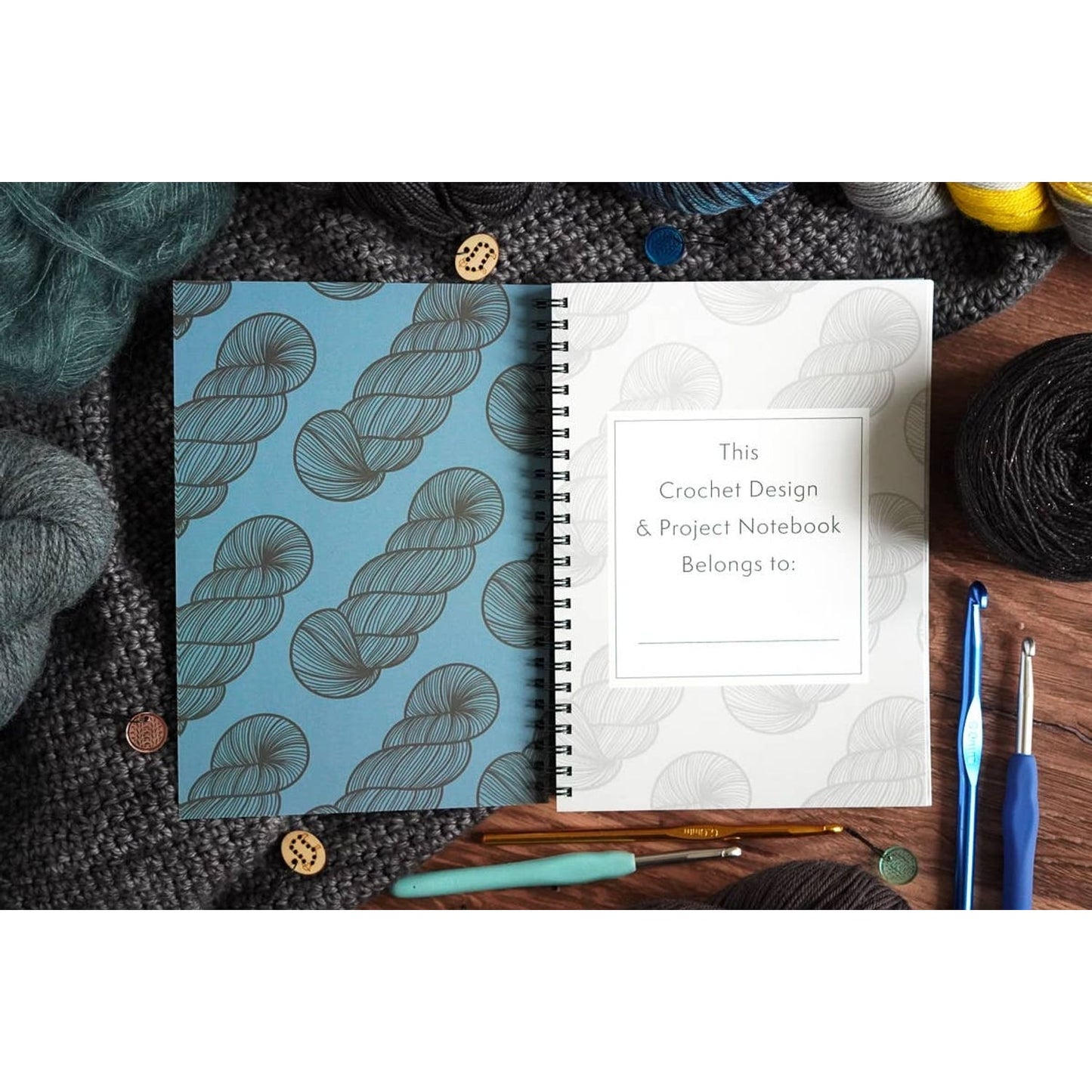 Spiral crochet design and notebook with skein pattern cover surrounded by yarn and hooks crochet pattern organizer notebook