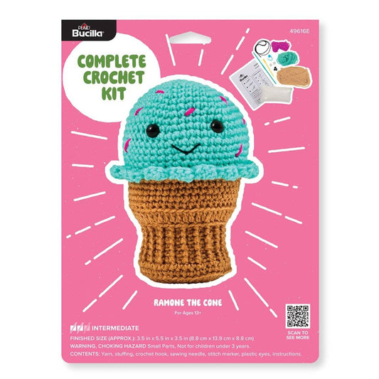 Bucilla amigurumi crochet kit turquoise smiling ice cream cone plush on pink packaging from Plaid Crafts