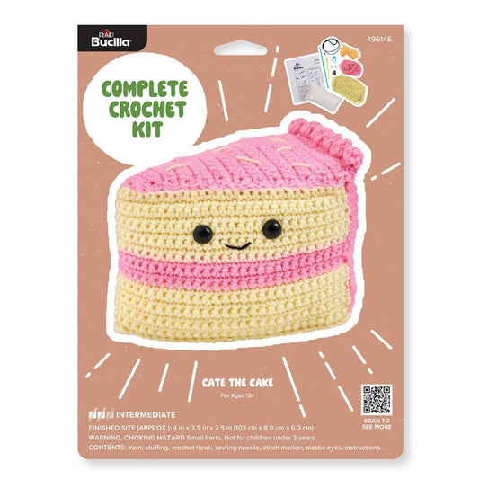 Plaid Crafts Cate the Cake crochet kit packaging showing pink yellow cake plush and materials beginner amigurumi crochet project