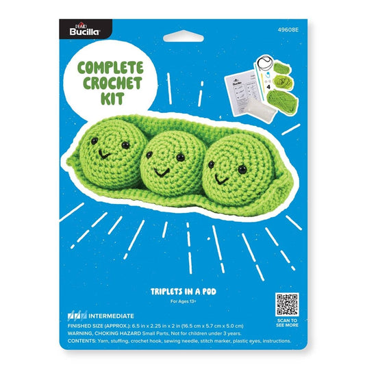 Plaid Crafts Bucilla amigurumi triplets crochet kit packaging showing three smiling green peas in a pod